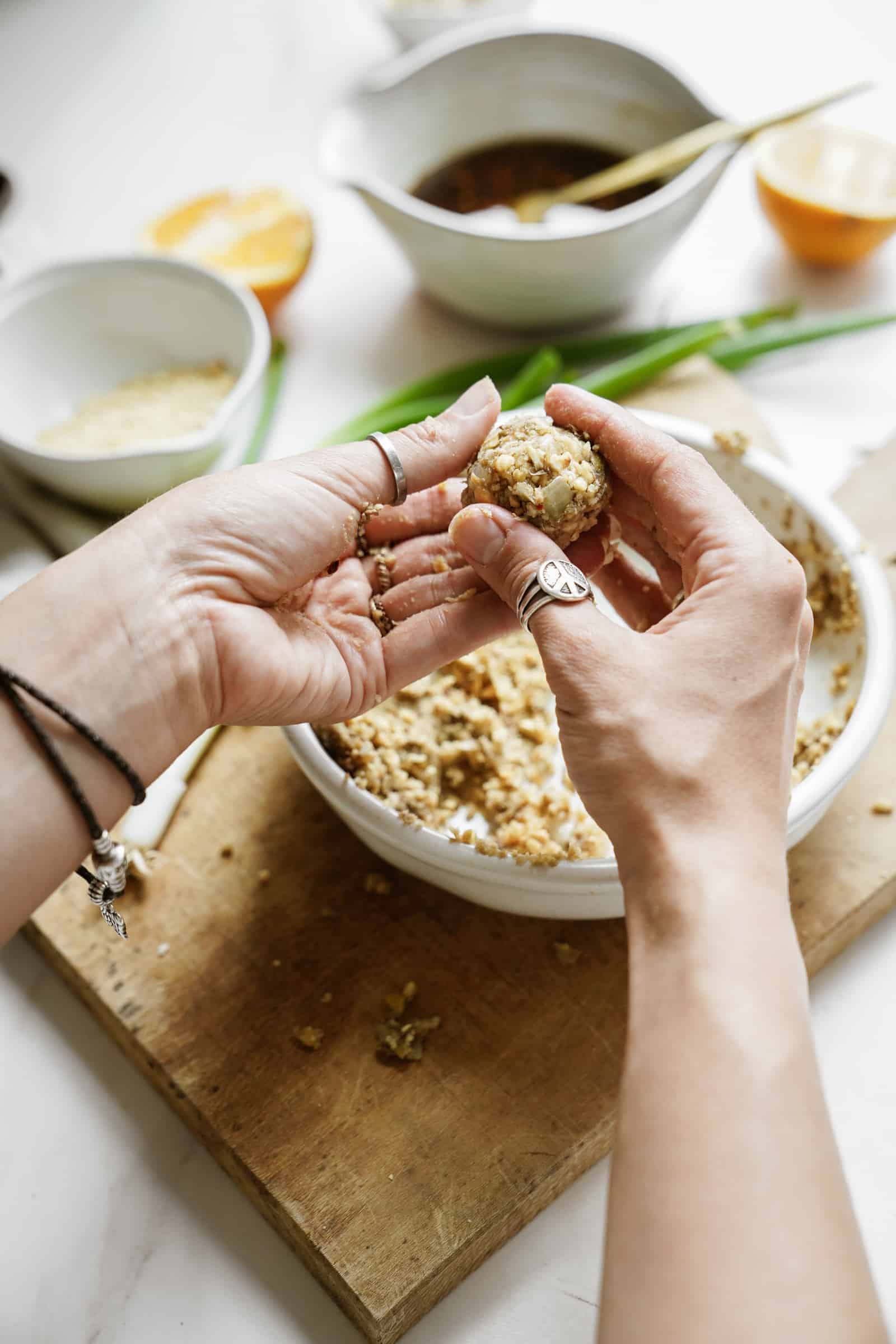 Hands rolling meatballs