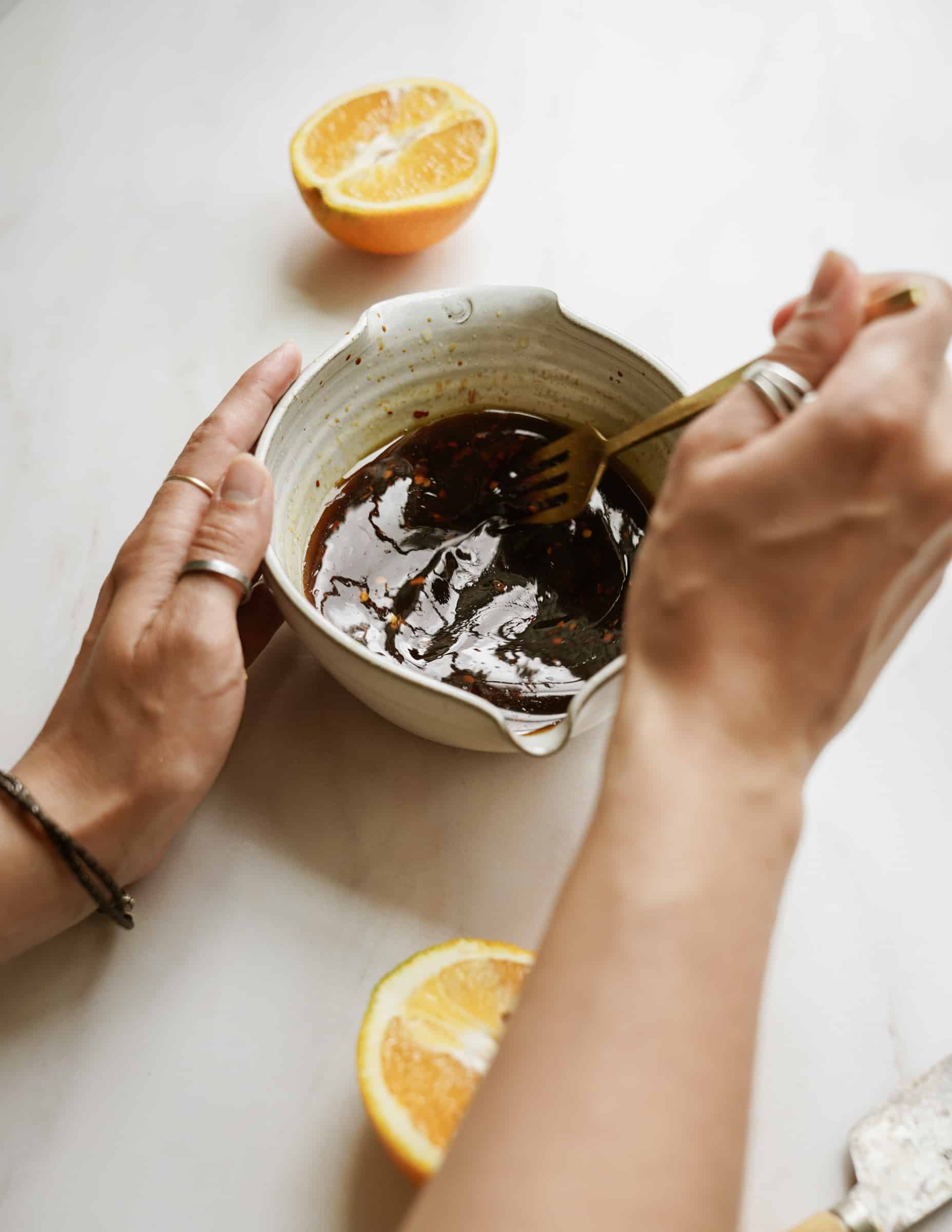 Ingredients being mixed in a bowl for sticky sesame sauce