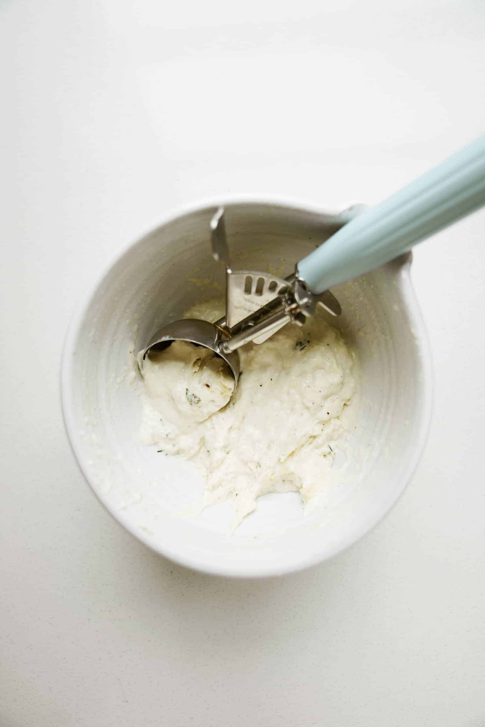 Ice cream scoop in a dough in a bowl
