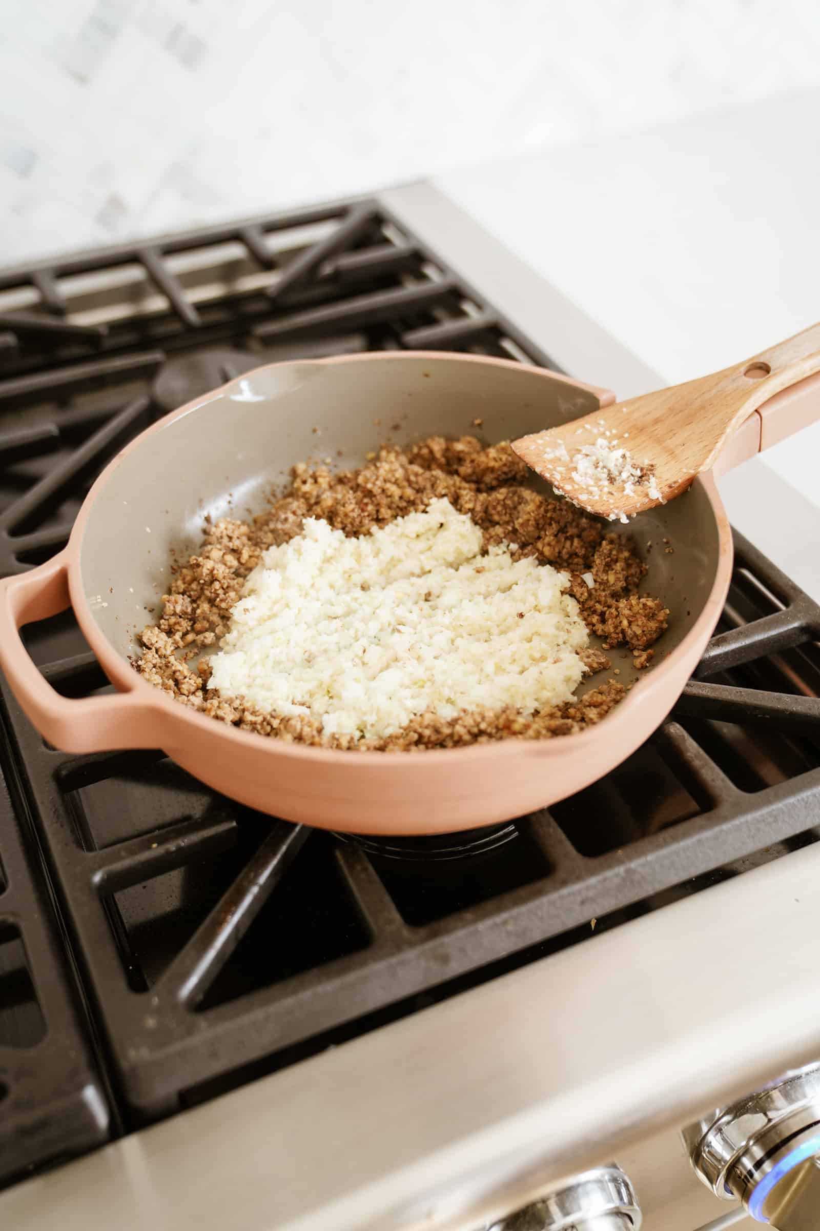 Walnut meat with onions and garlic in a pan