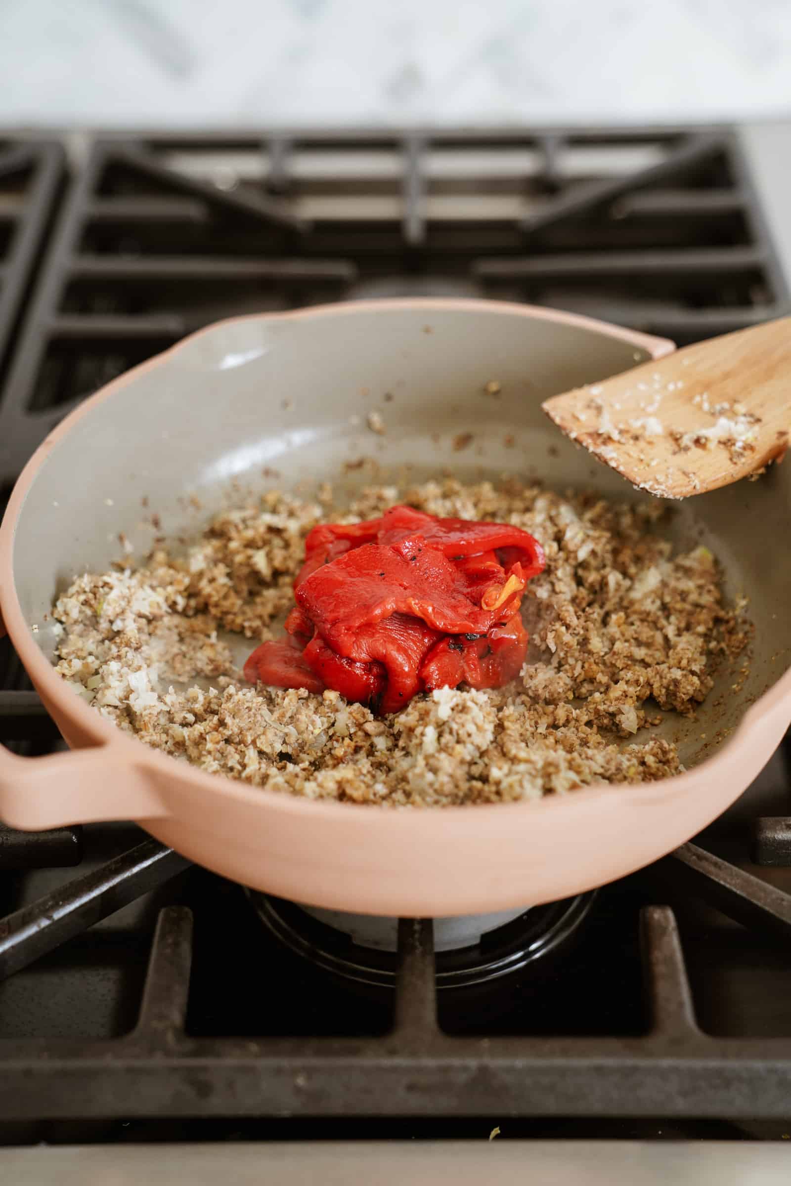 Roasted red peppers in a pan with walnut meat