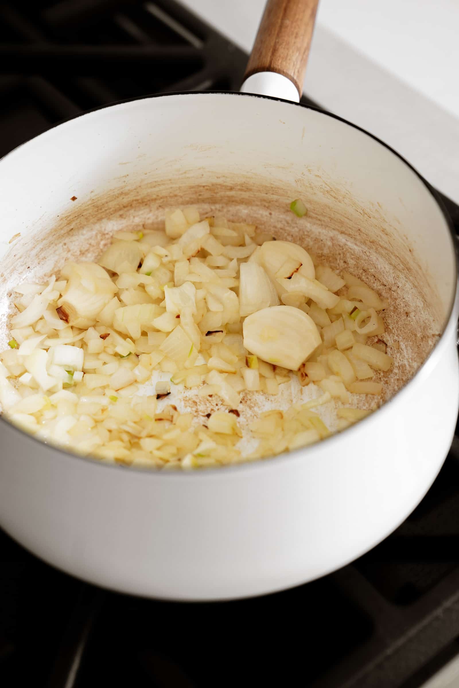 Onion and garlic cooking in a pot on the stove