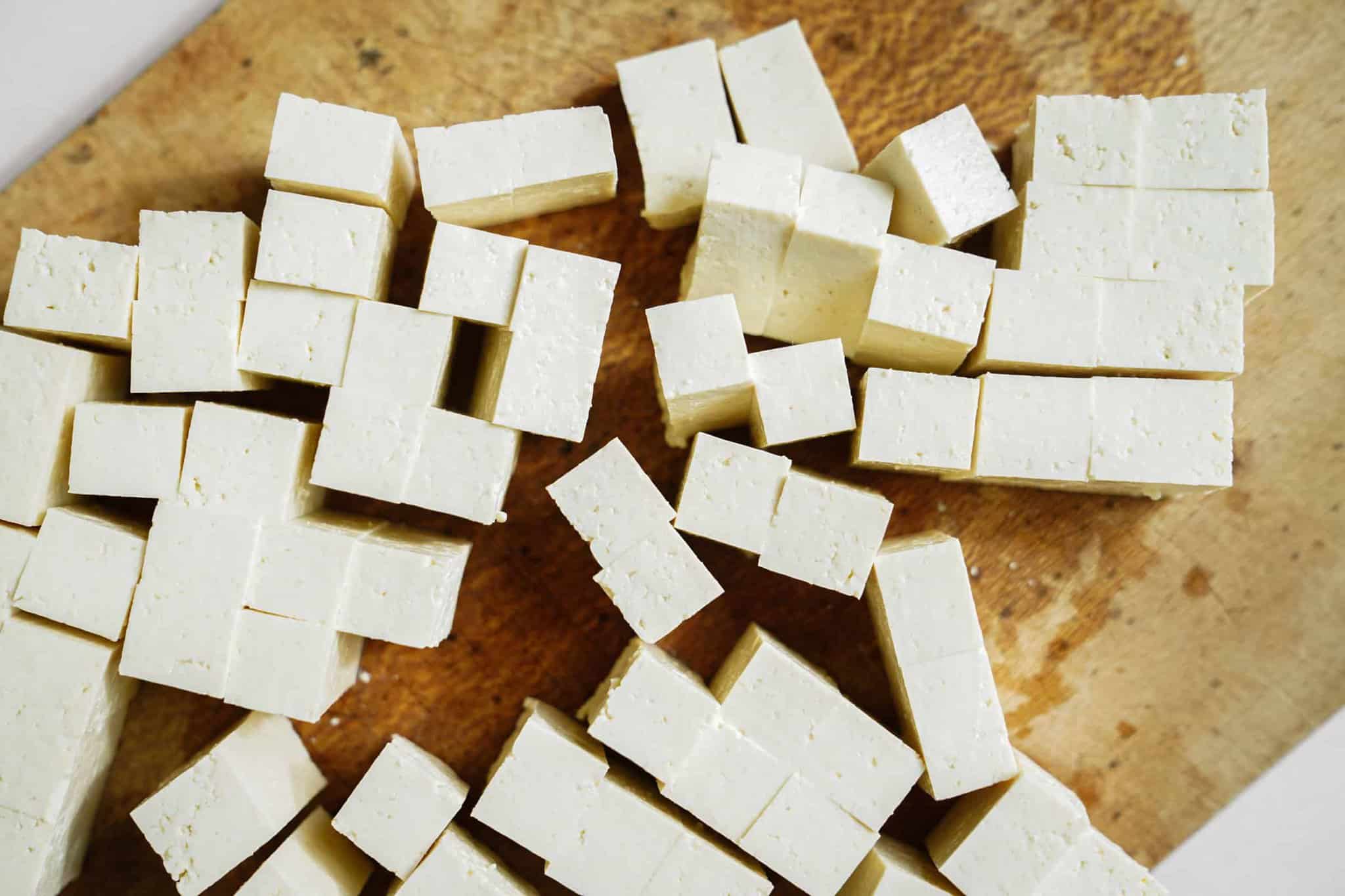 Tofu on a cutting board for Marinated Tofu and Vegetable Skewers