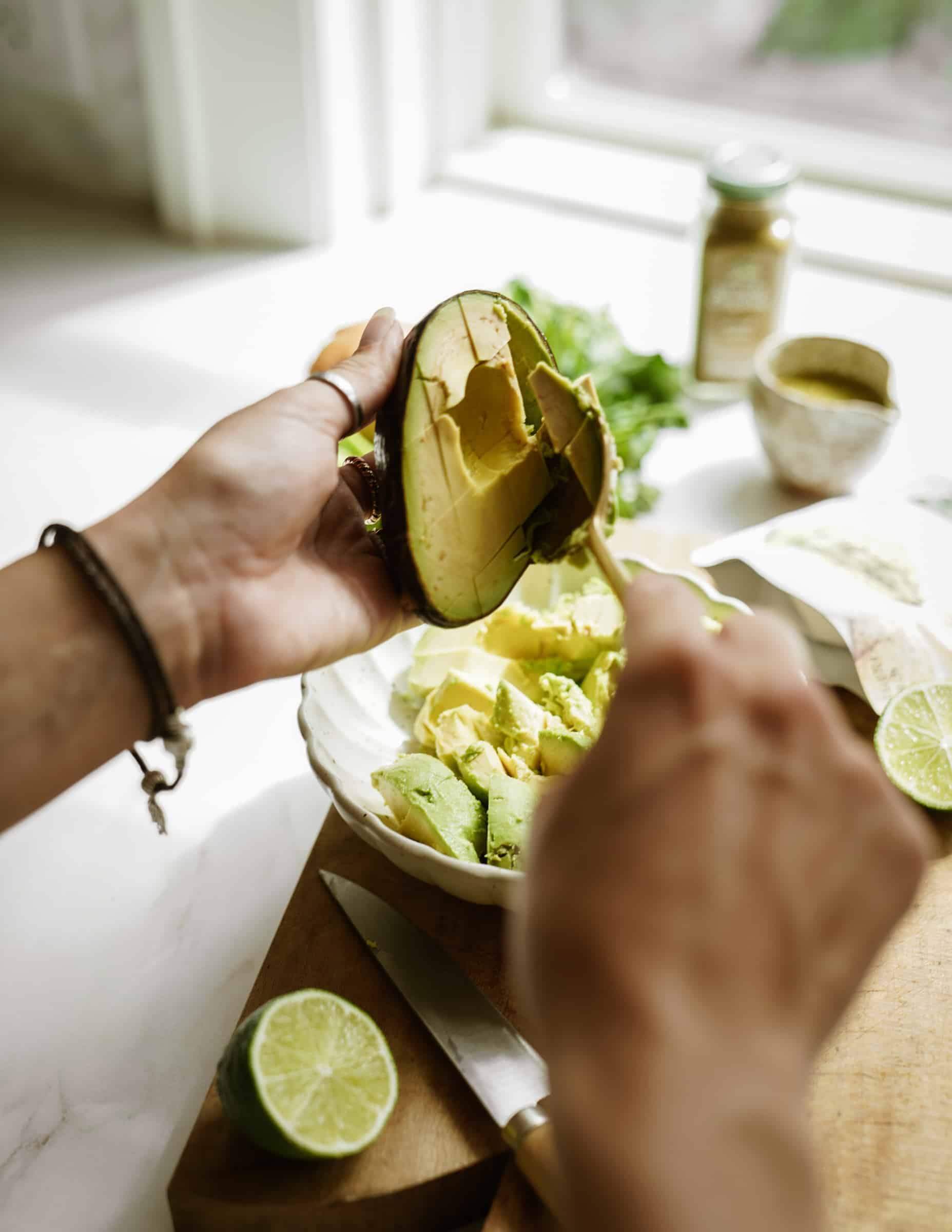 Scooping avocado out of a avocado