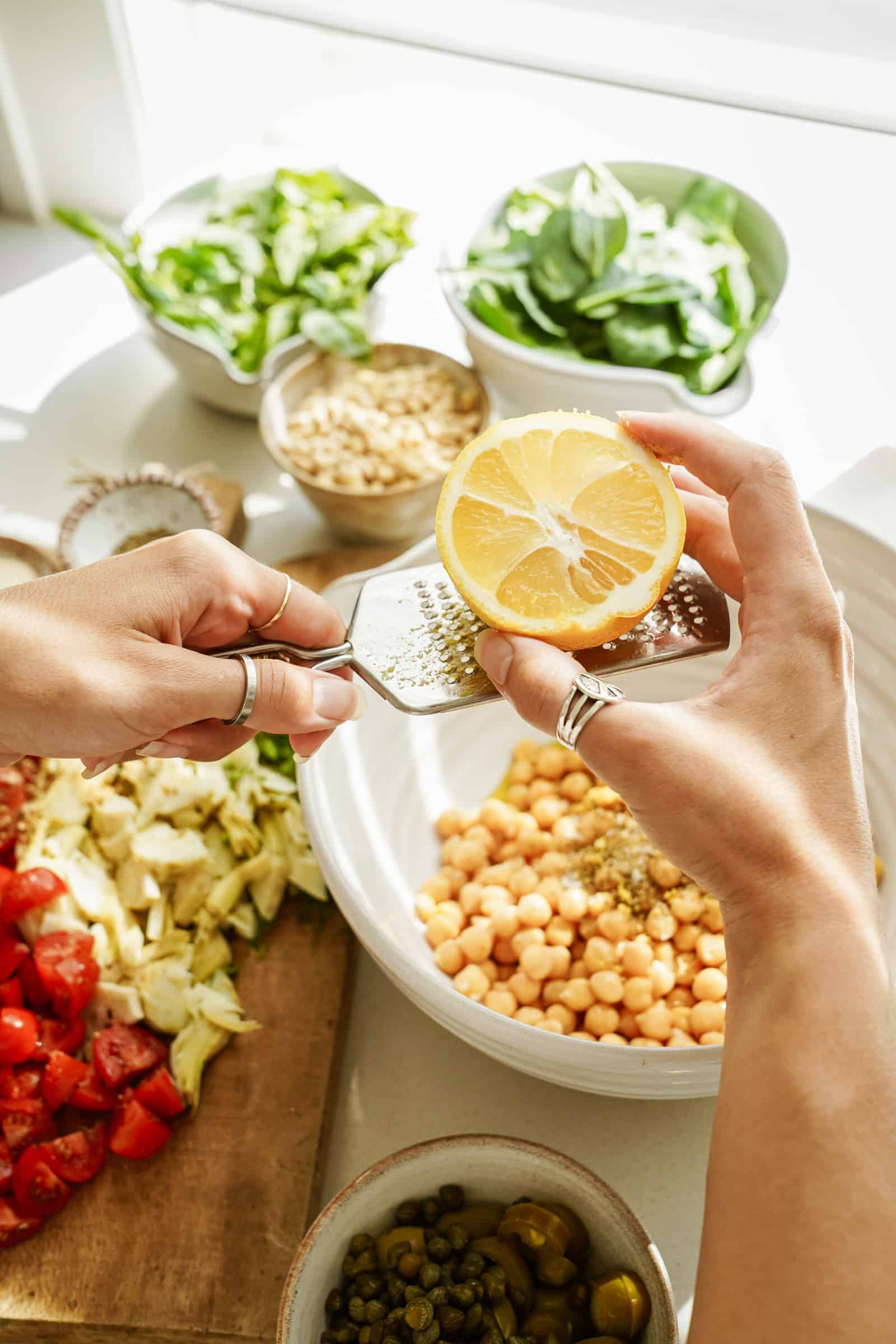 Zesting lemon in a bowl of chickpeas