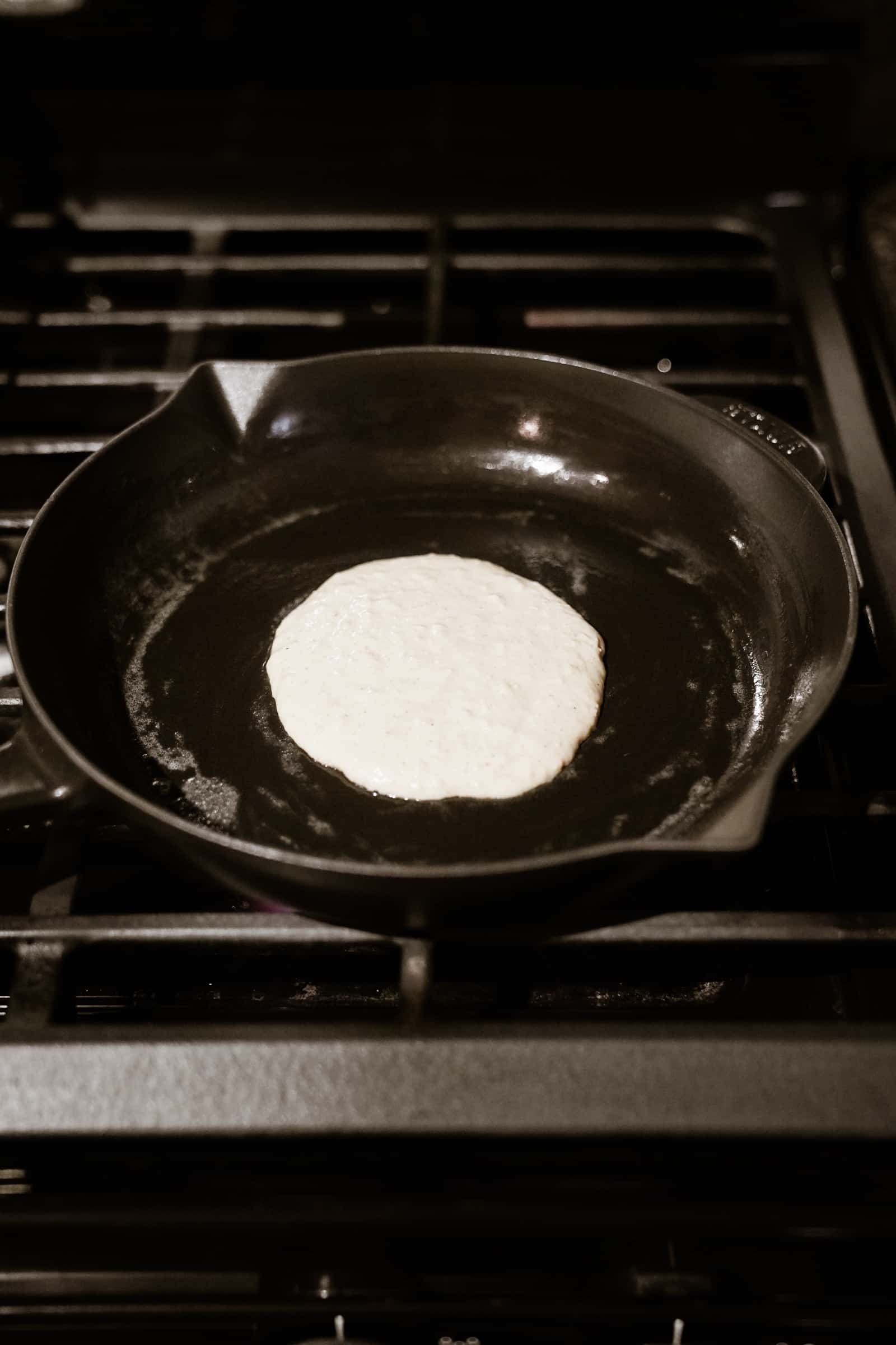 Pancake cooking on cast iron skillet