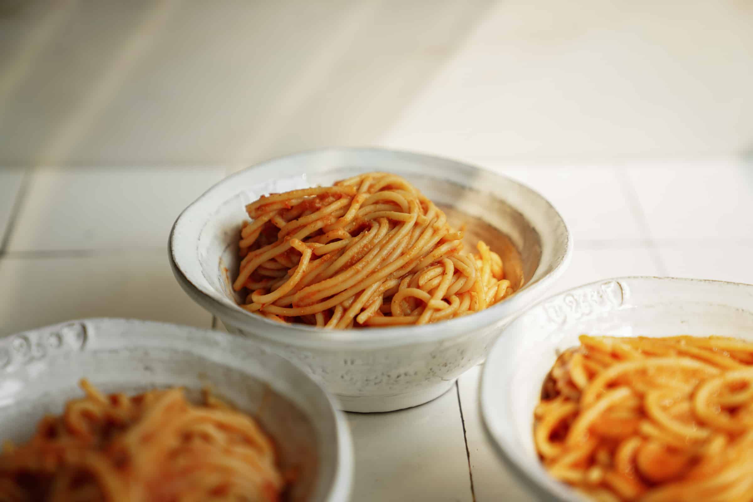 Bowls of spaghetti with Greek pasta sauce on it