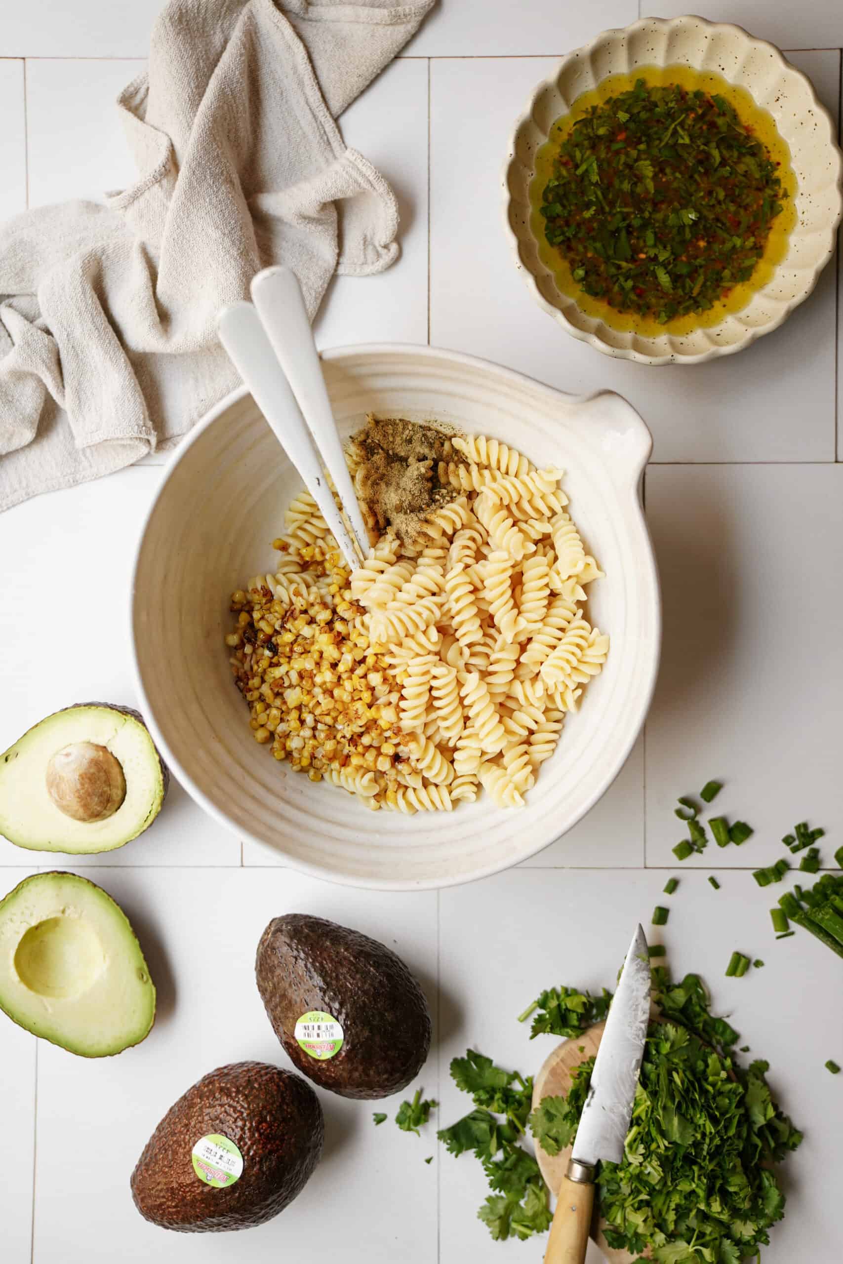 Ingredients for avocado pasta salad on a countertop