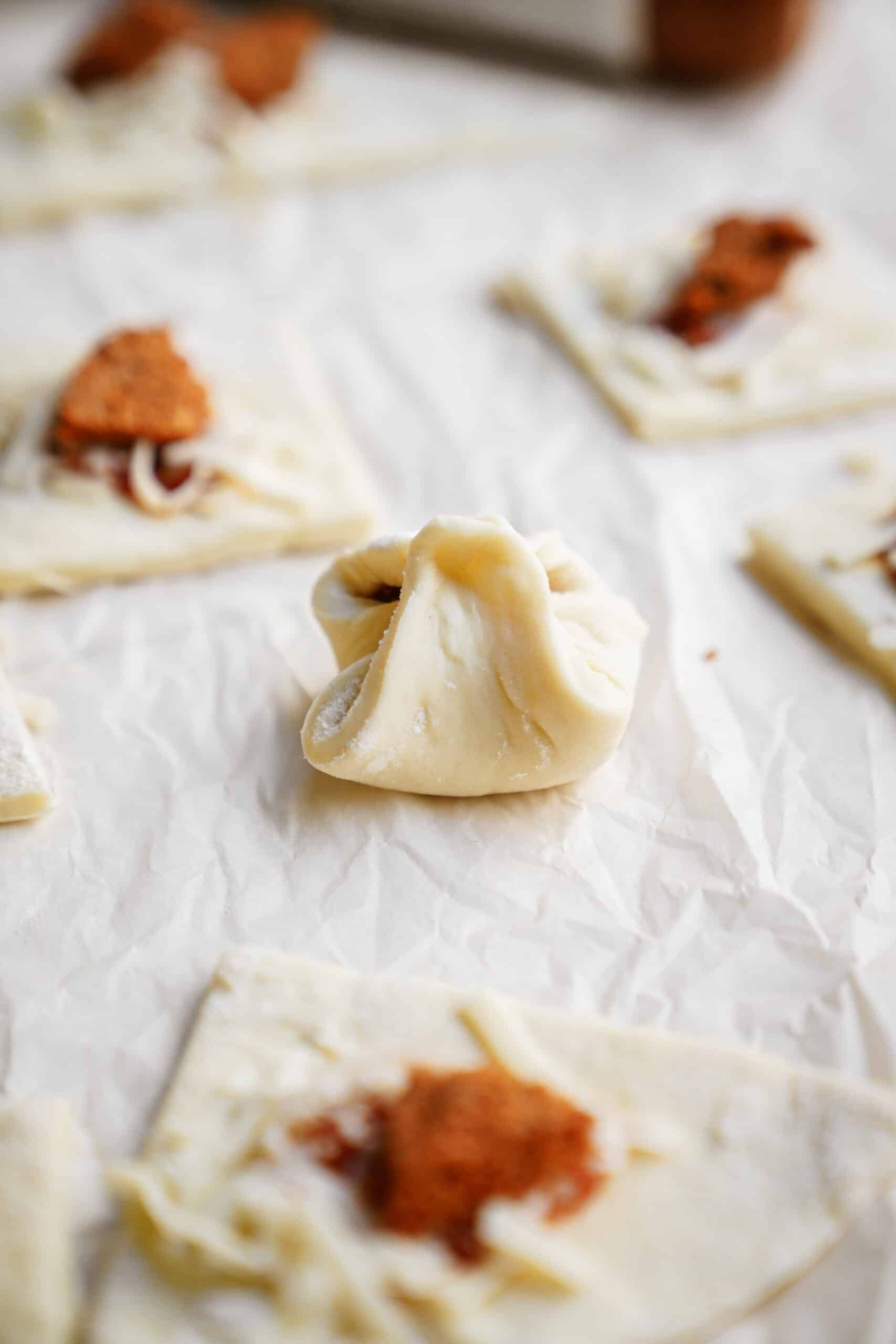 Homemade Pizza Pockets on parchment paper