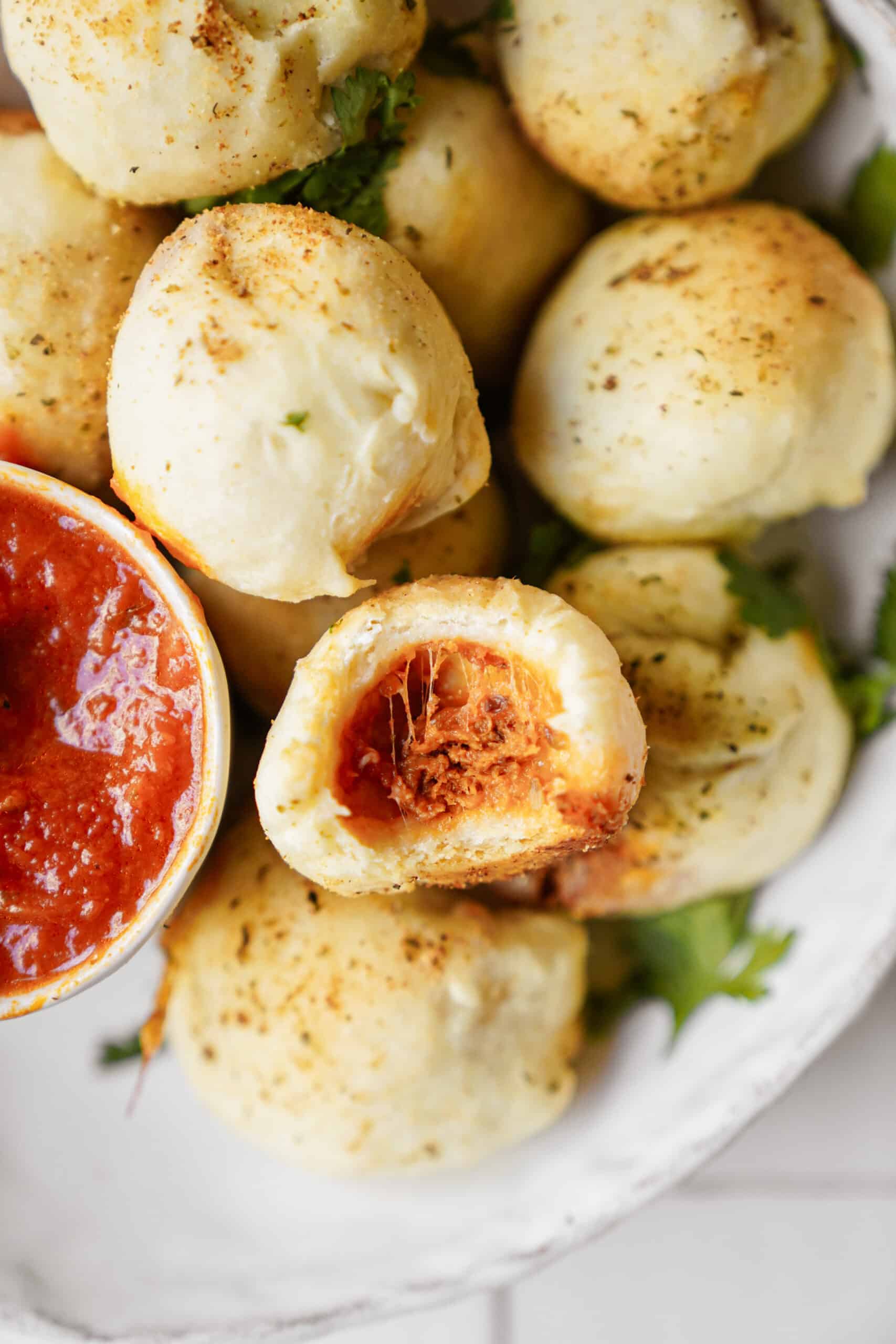 Close-up of homemade pizza pockets with dipping sauce