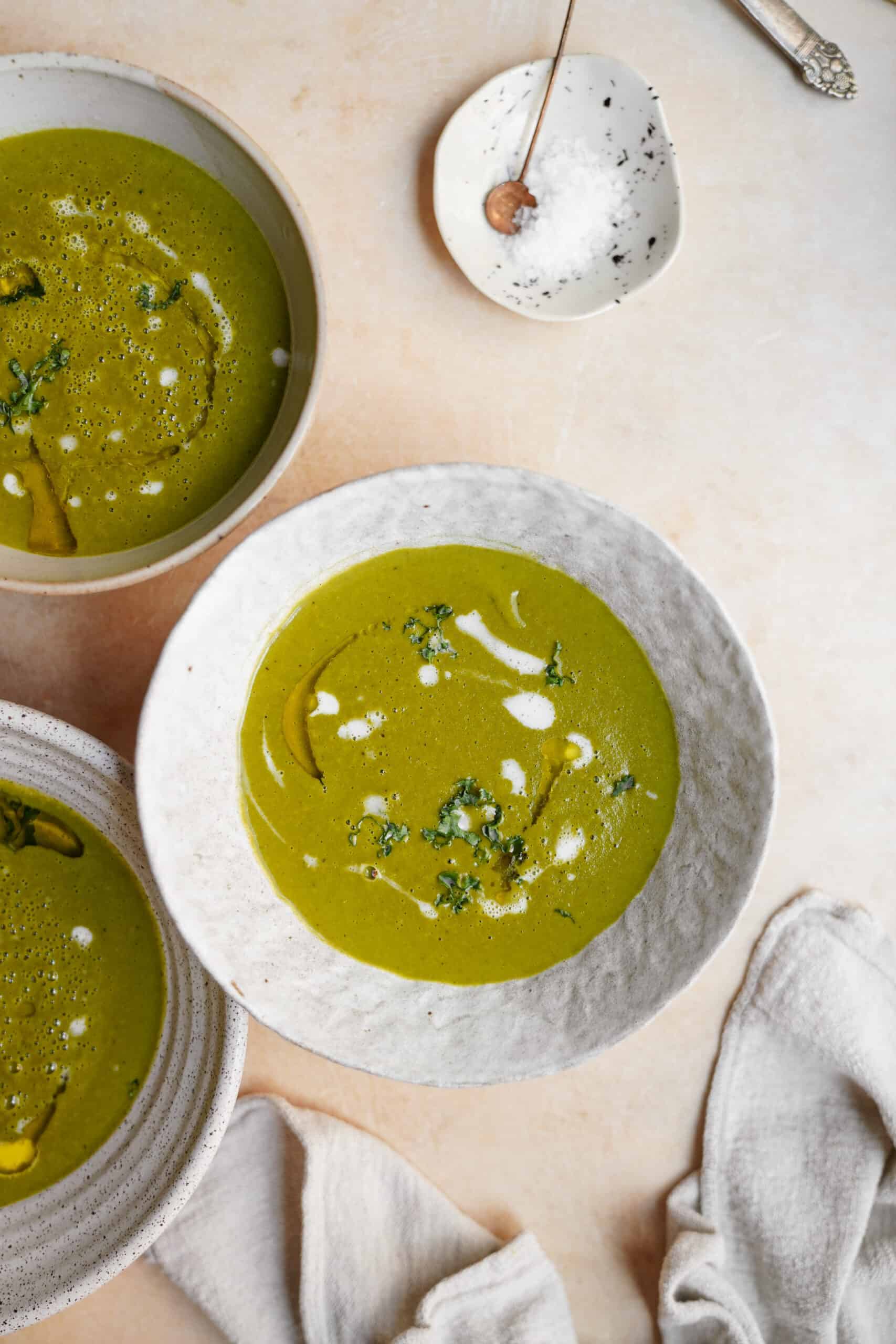 potato kale Soup in white bowls on countertop