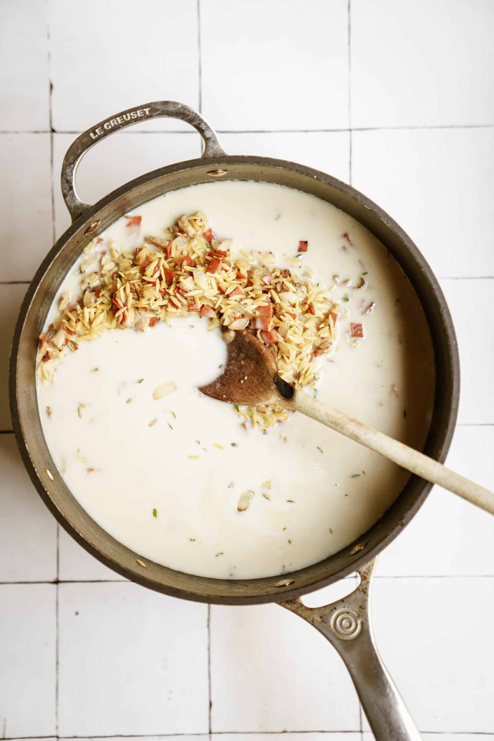 Orzo and cream in a pan