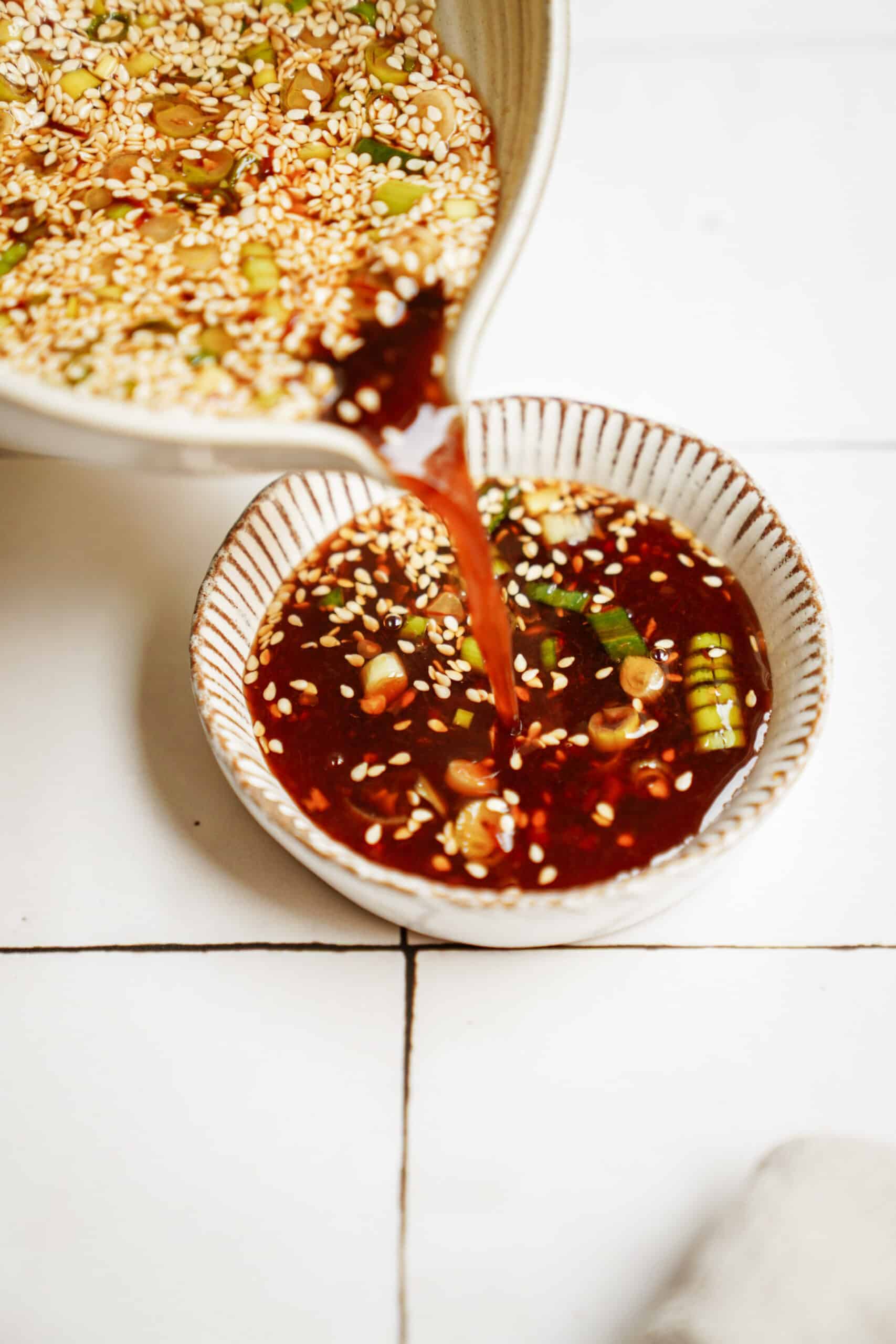 Potsticker sauce being poured into a small serving dish