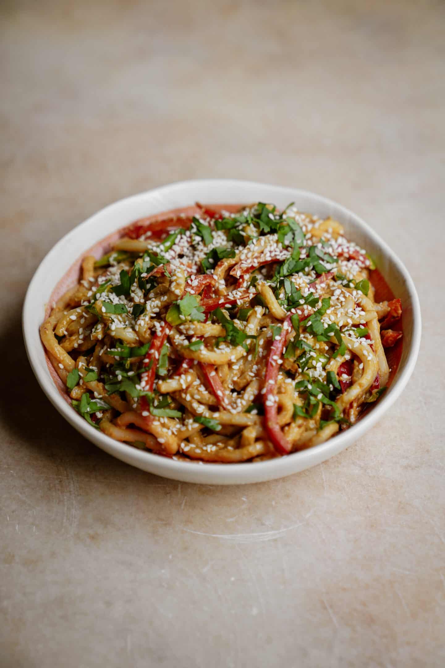 Spicy udon noodles in a white bowl