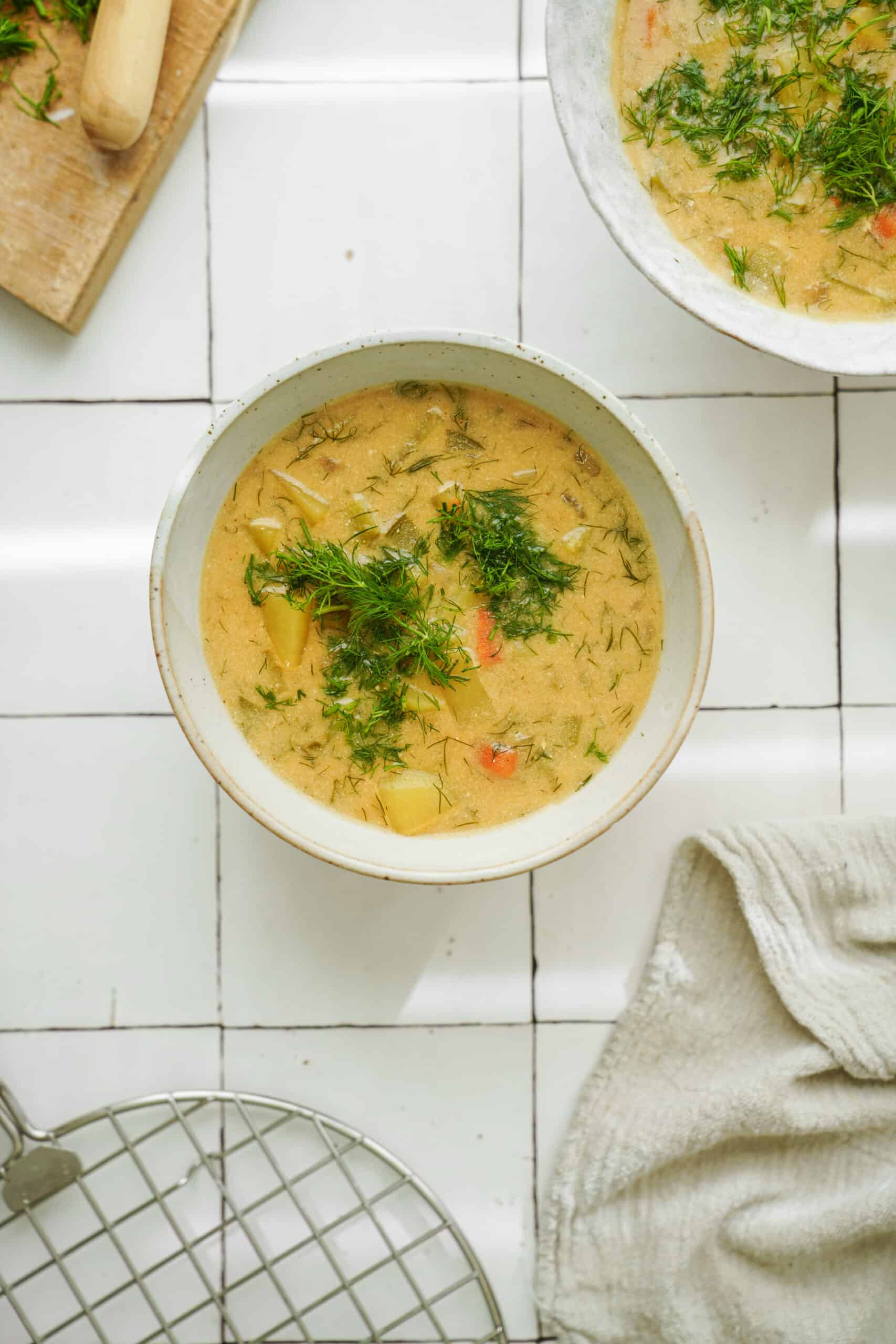 Dill pickle soup in a white bowl