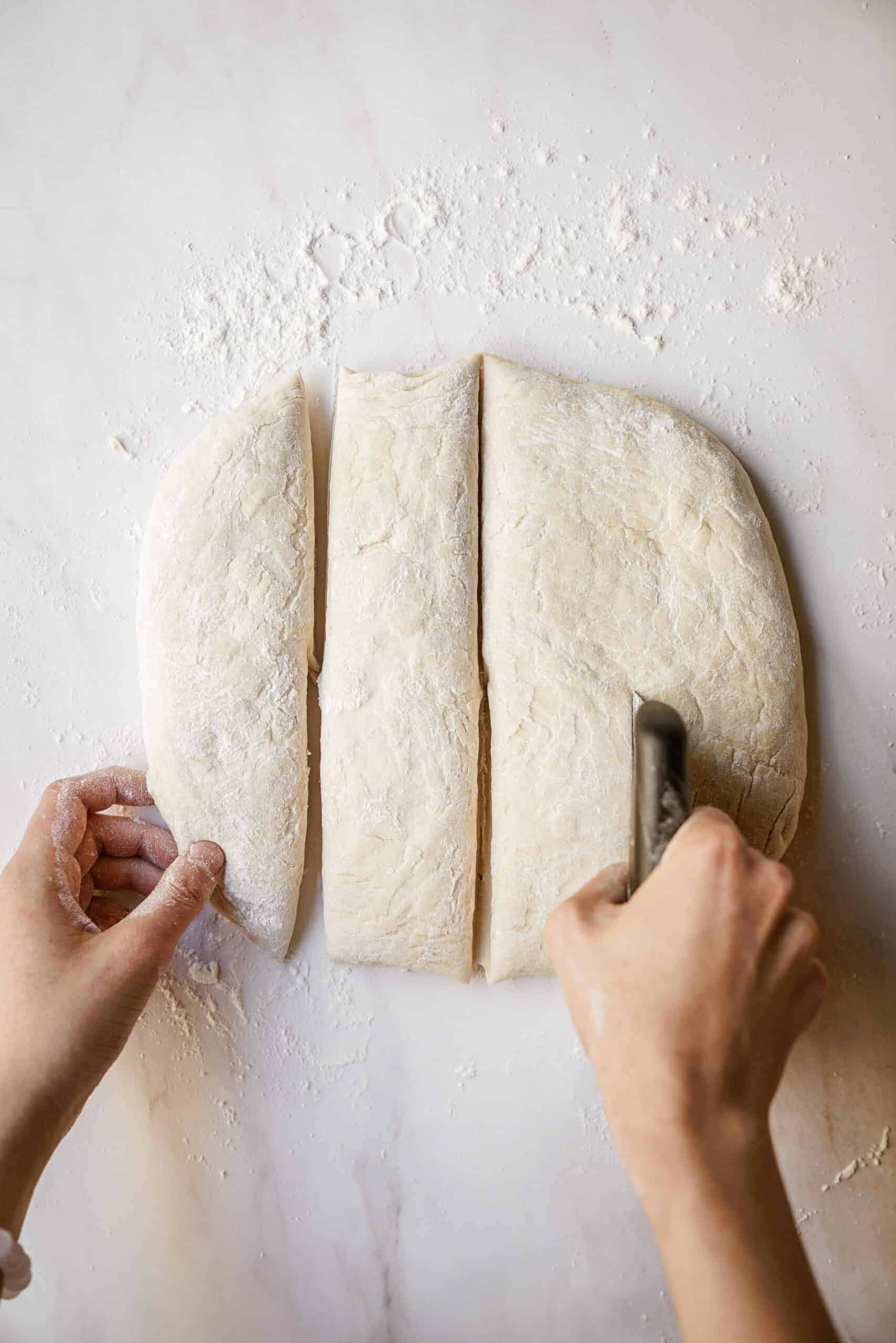 Dough being cut into squares 