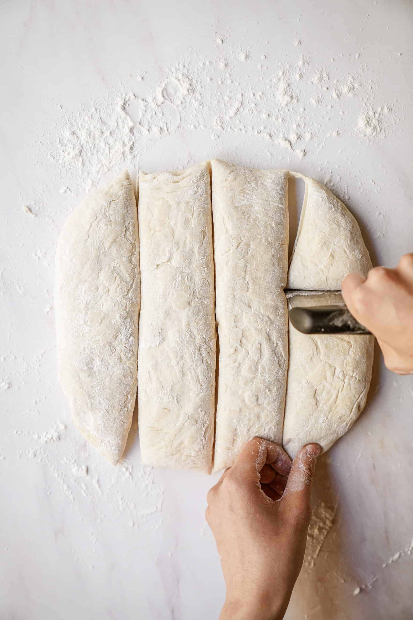 Dough being cut into squares 