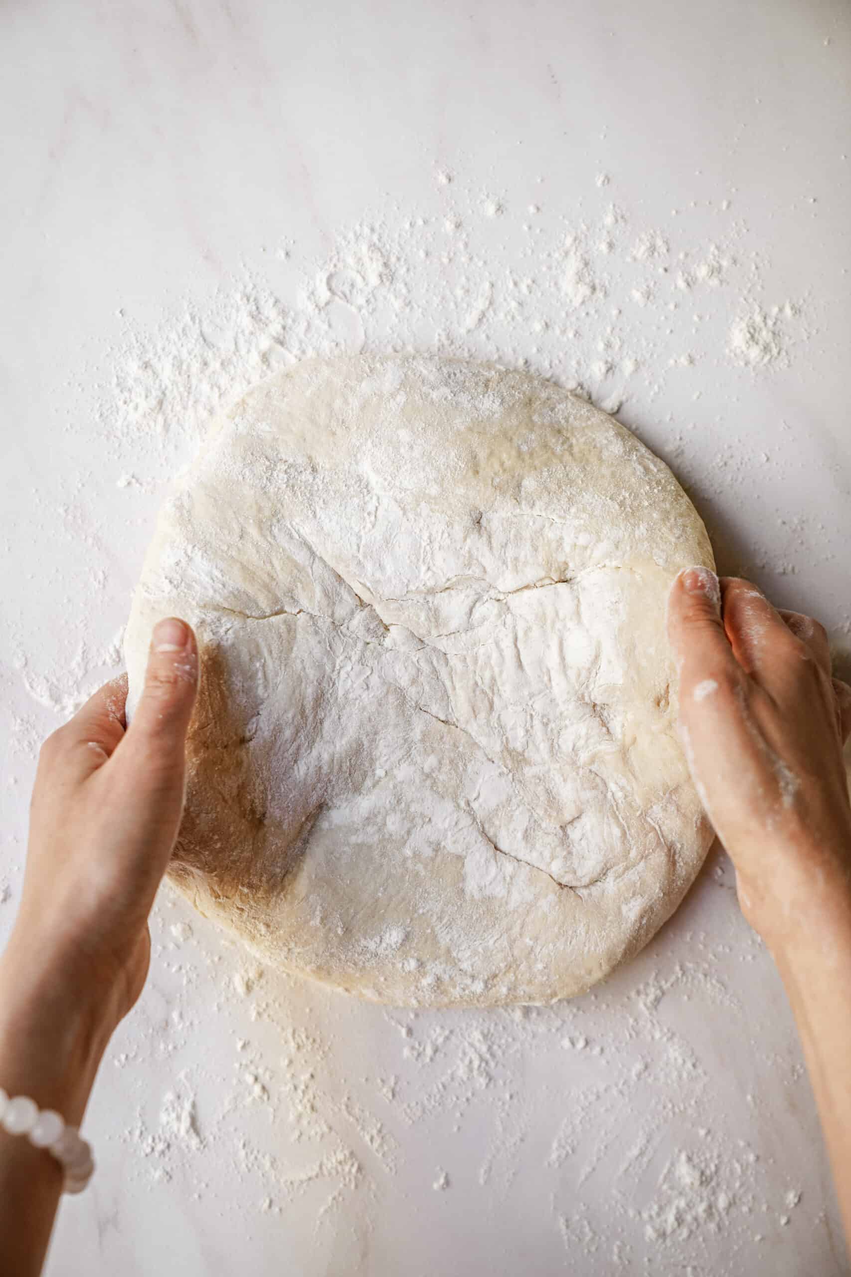 Dough rolled out with flour on counter