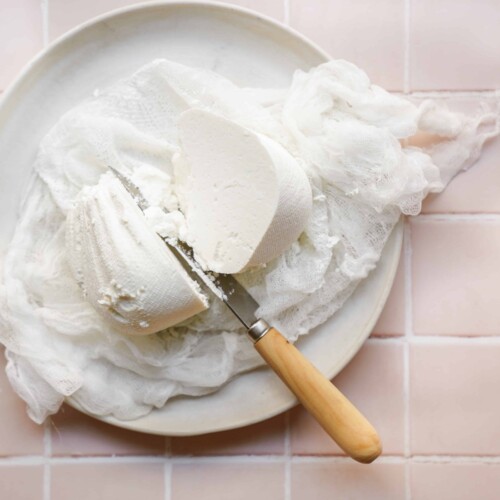 Knife cutting into labneh