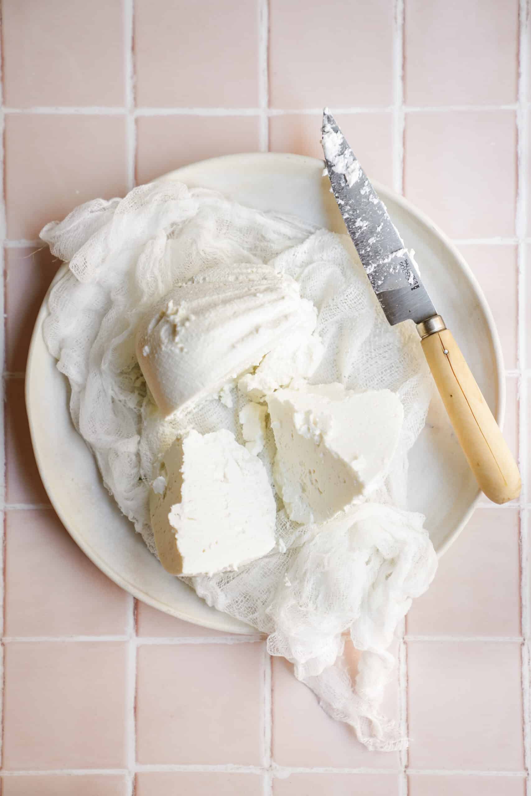 Labneh on top of a cheese cloth with a knife