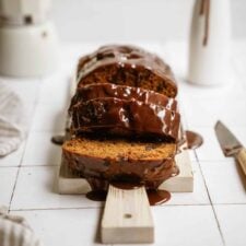 pumpkin chocolate chip bread sliced on a cutting board