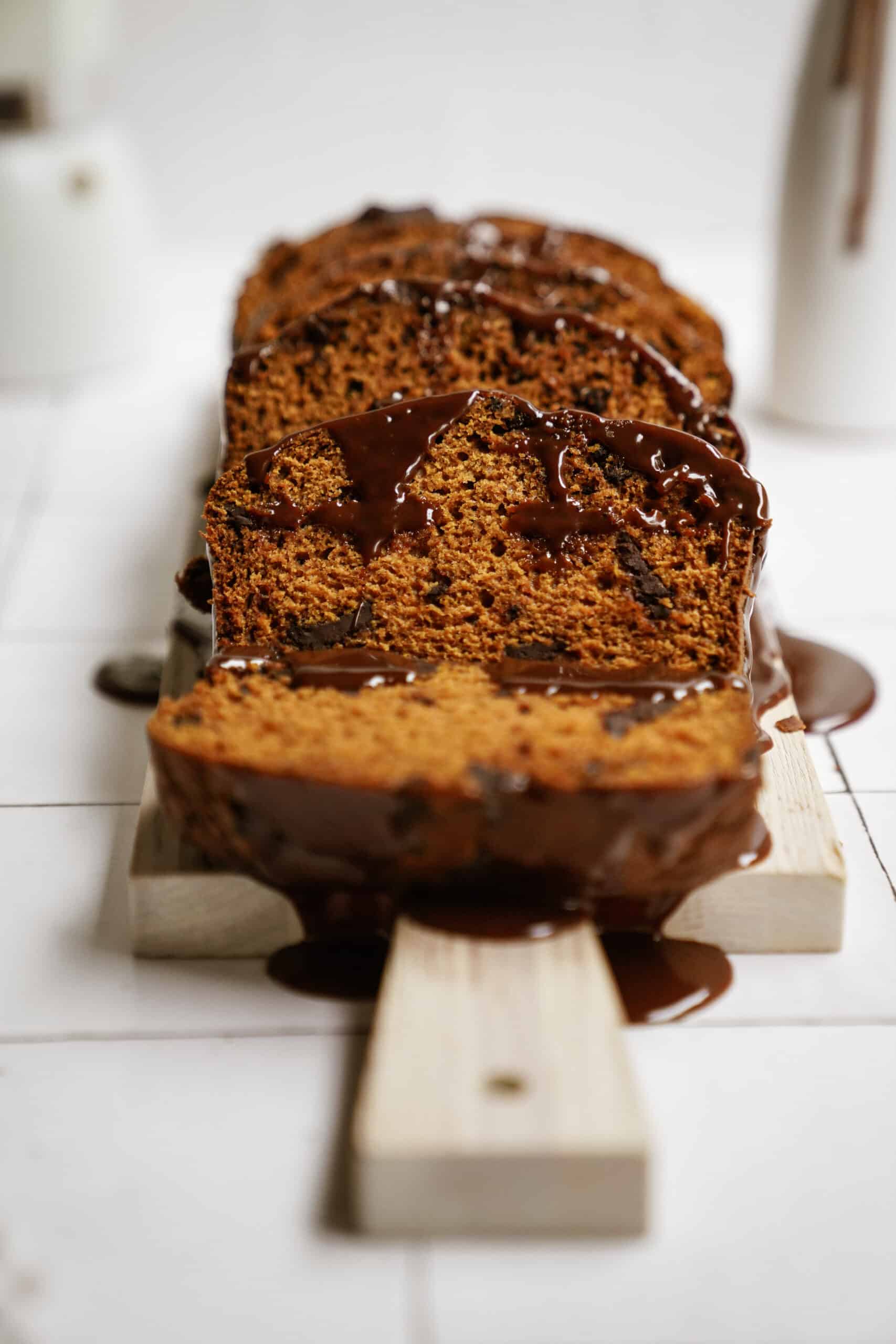 pumpkin chocolate chip bread sliced on a cutting board