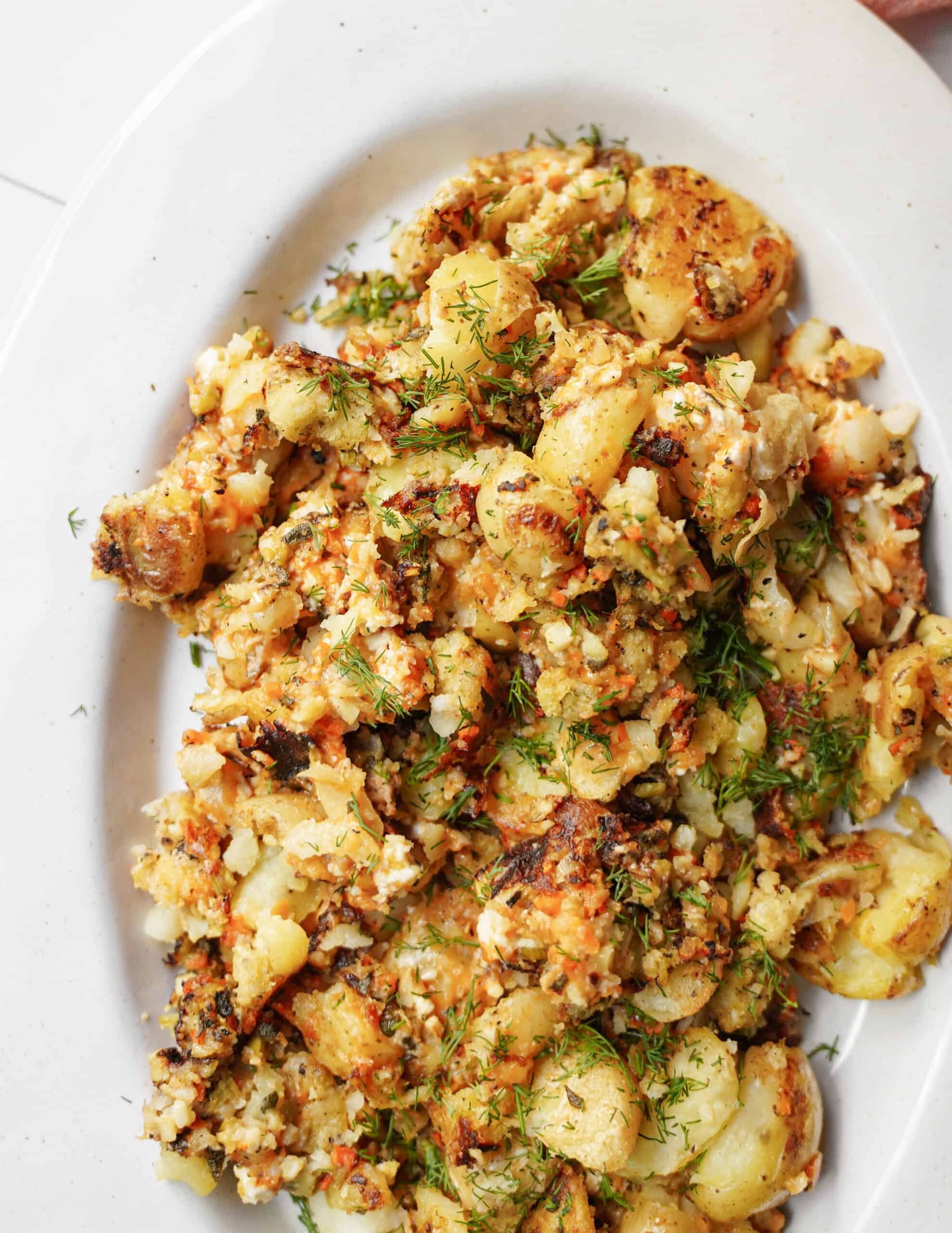 Smashed potatoes recipe on a white plate