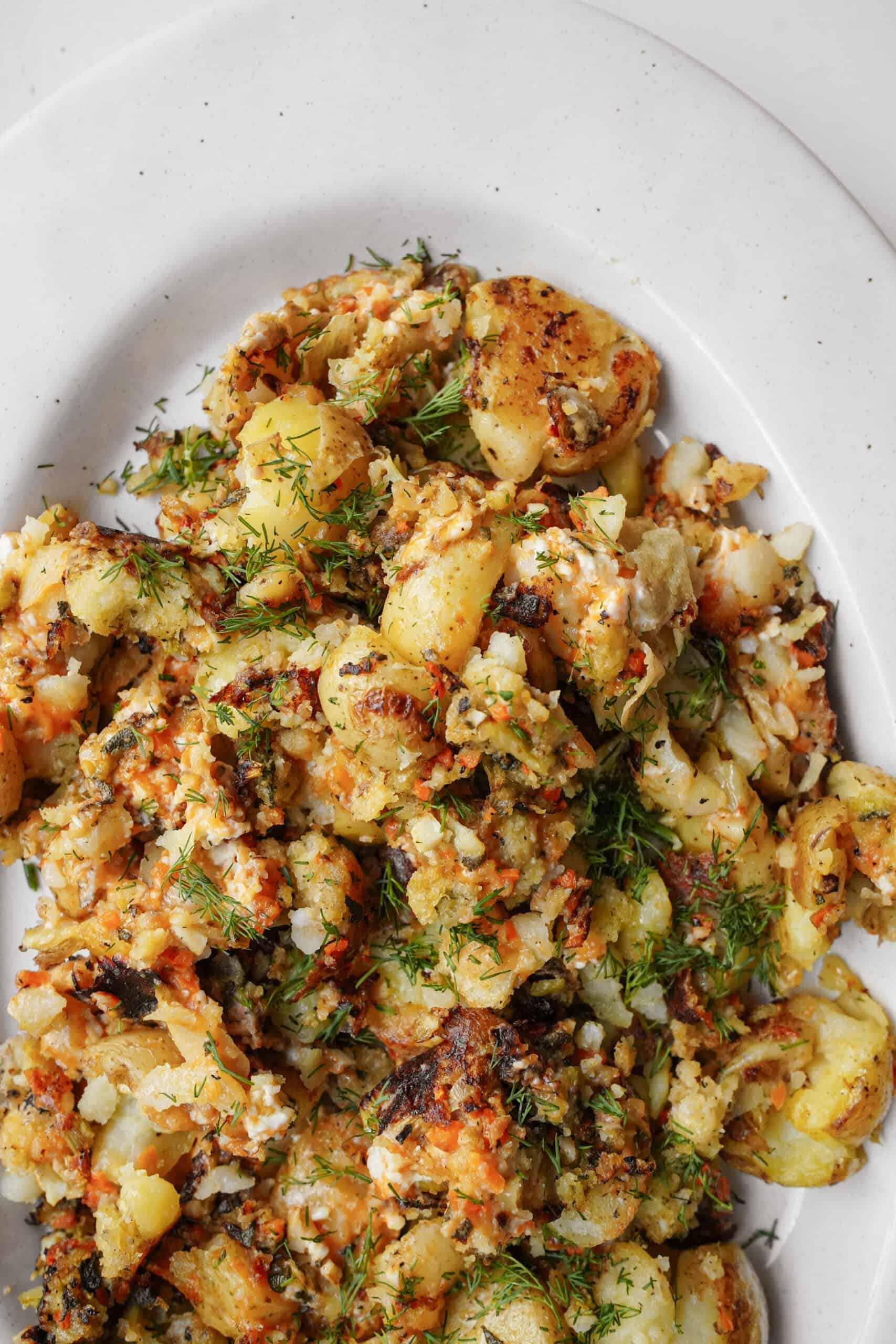 Smashed potatoes recipe on a white plate