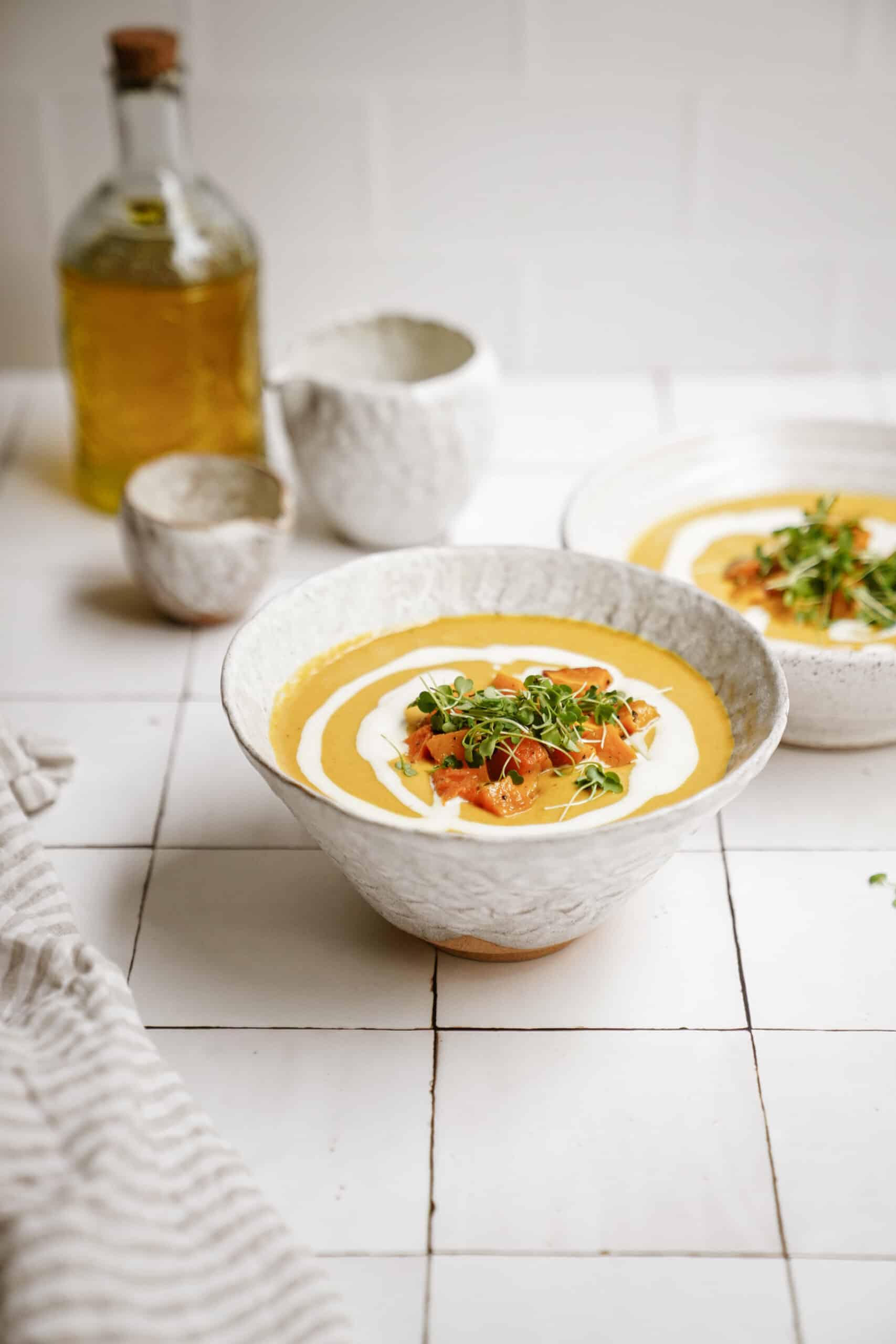 Vegan Pumpkin curry soup recipe in white serving bowls