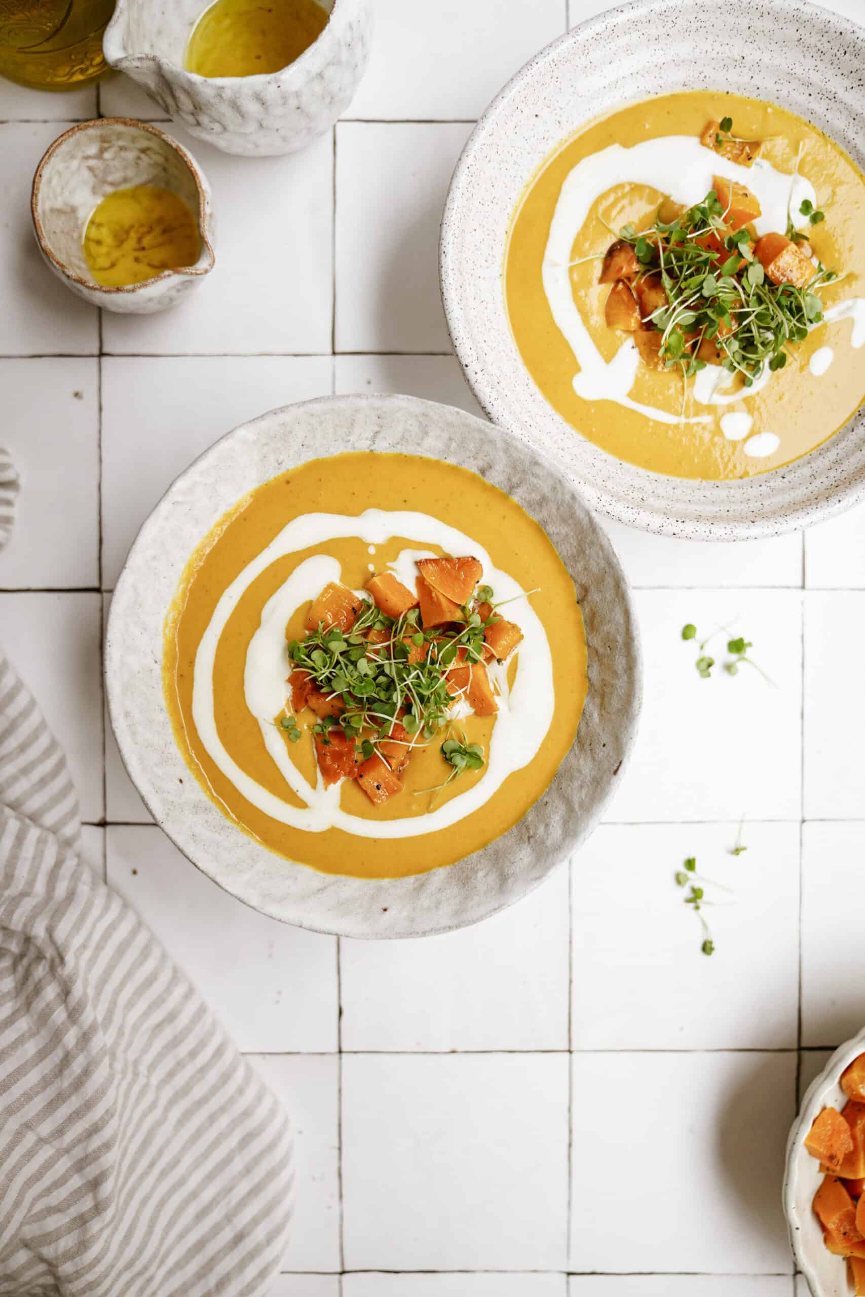 Pumpkin curry soup in white bowls