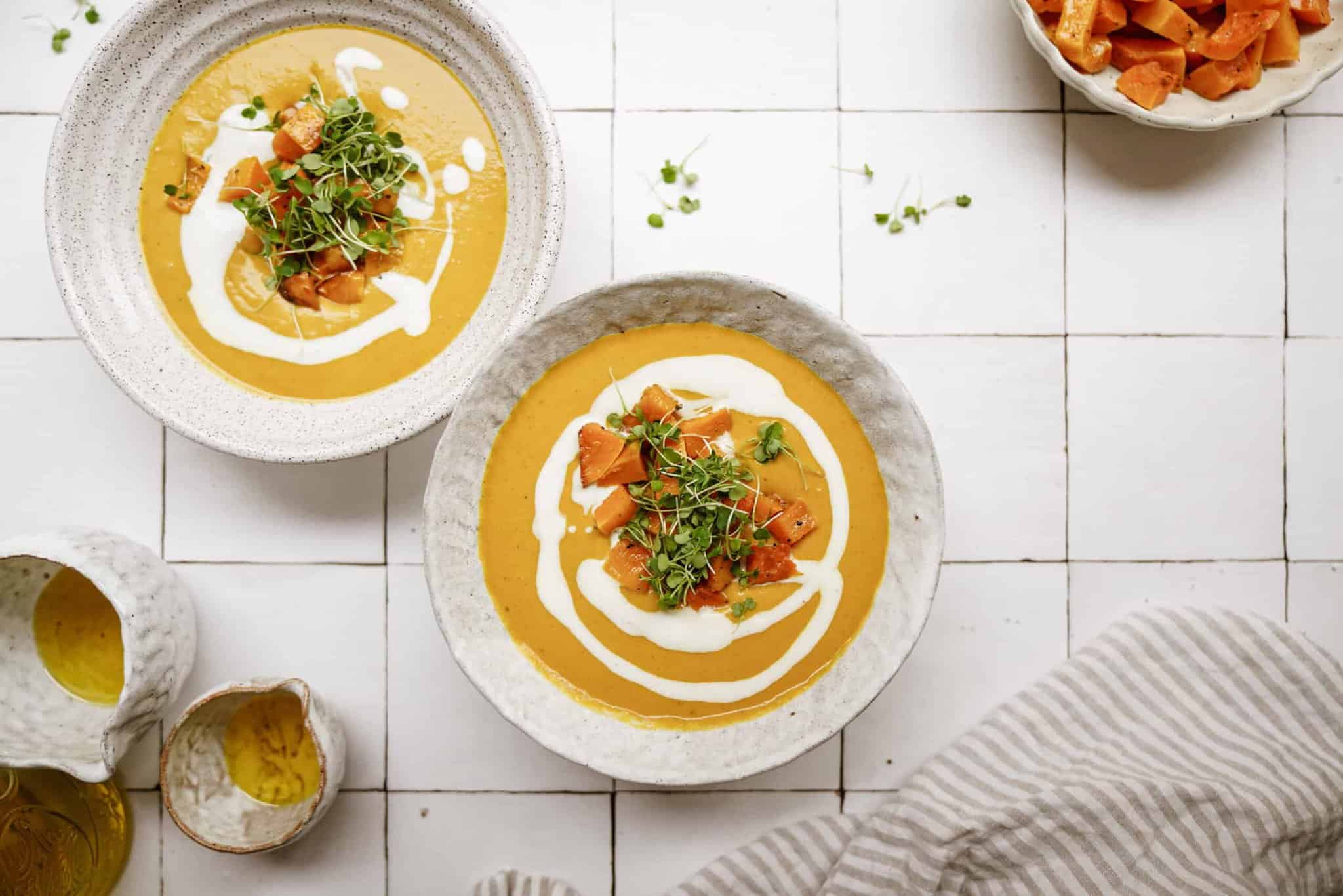 Pumpkin curry soup recipe in white serving bowls