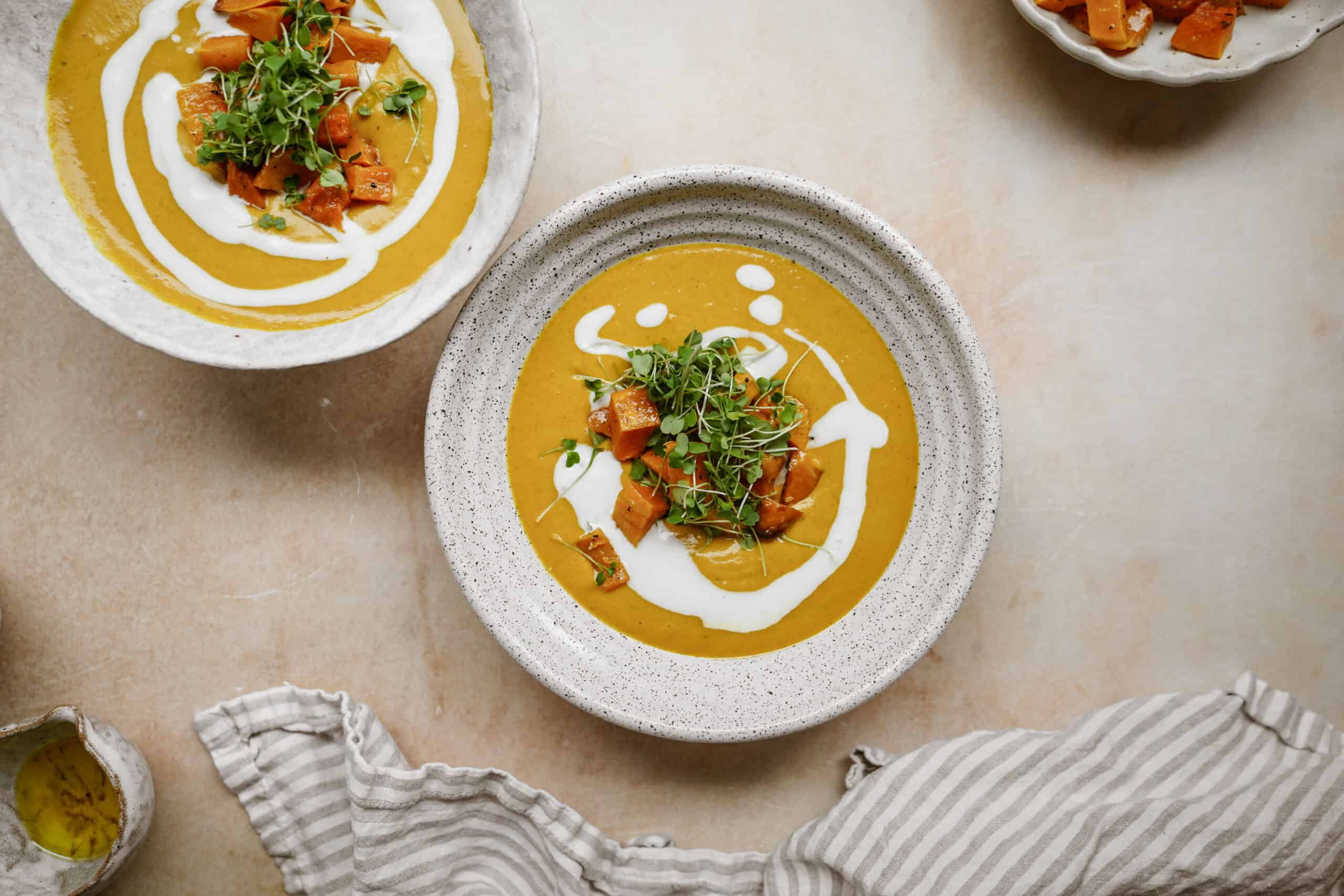 vegan Pumpkin curry soup recipe in white serving bowls