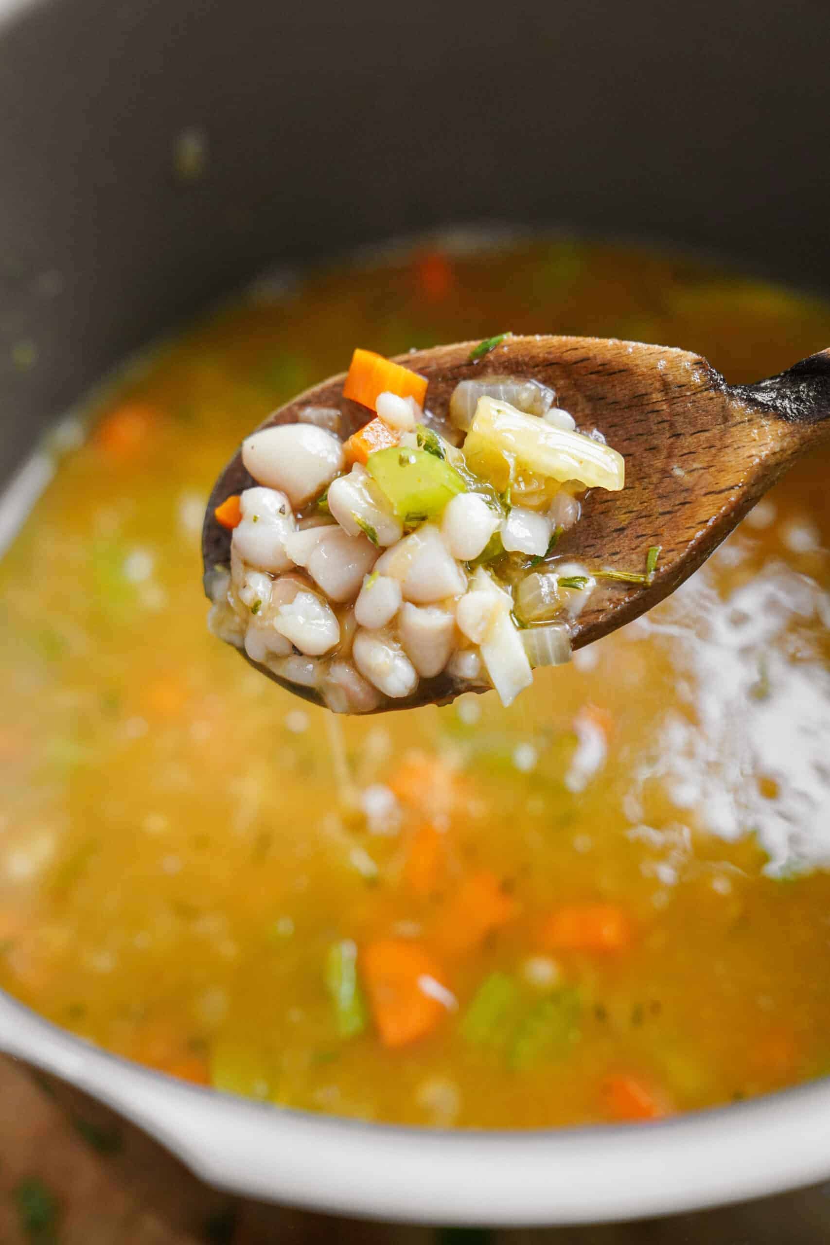 Ingredients for creamy white bean soup in a pot