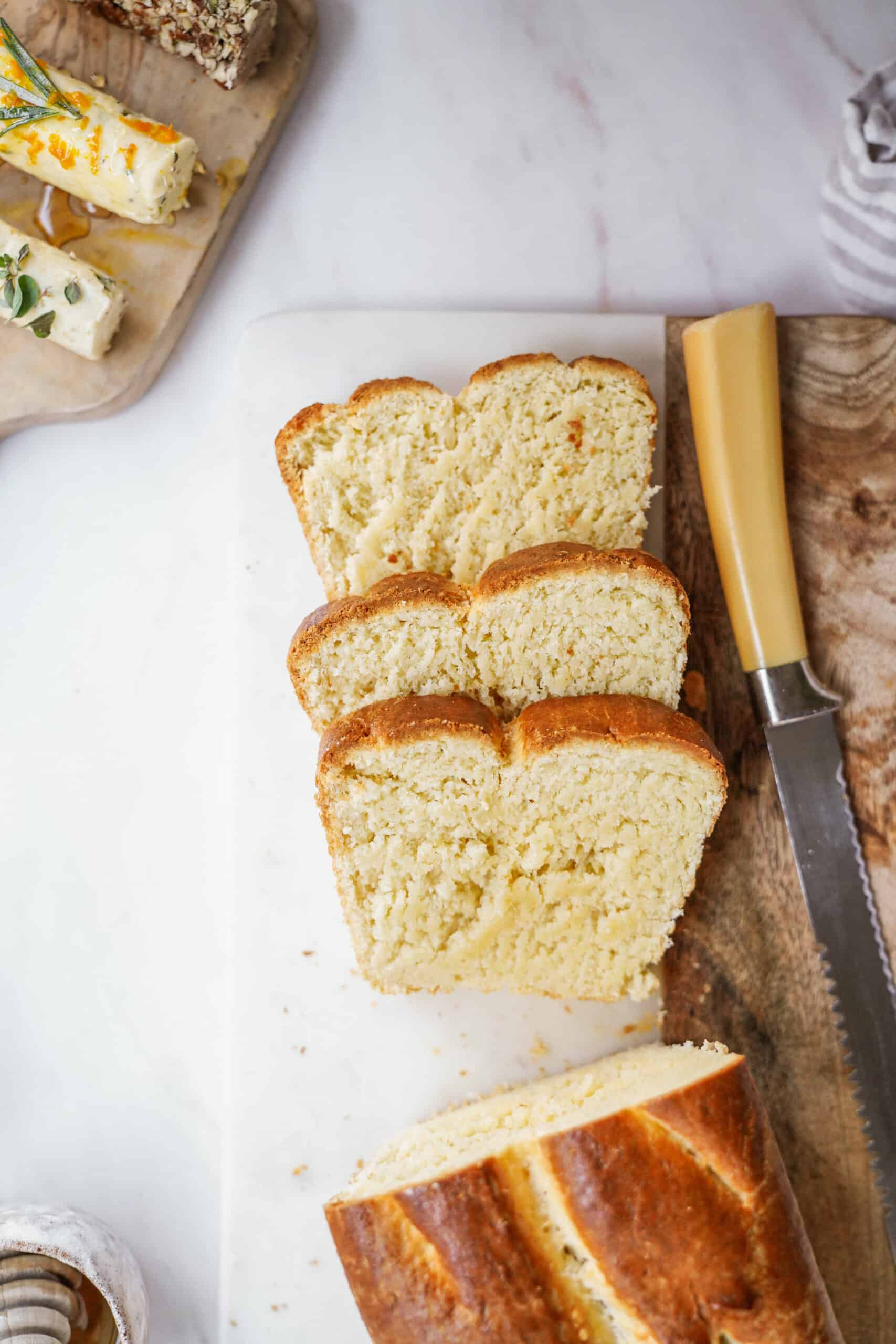 Brioche bread recipe on cutting board sliced