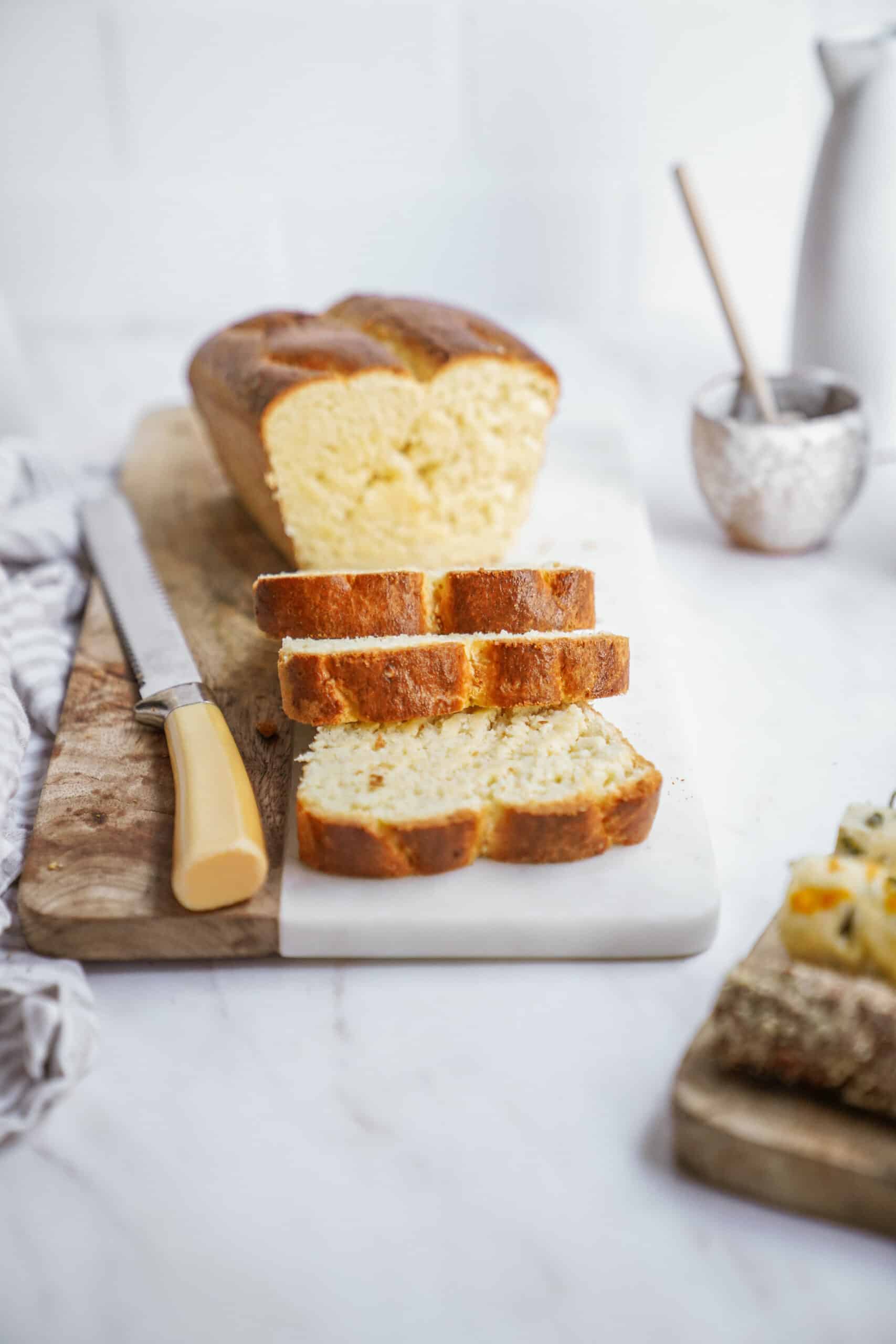 Brioche bread recipe on cutting board sliced