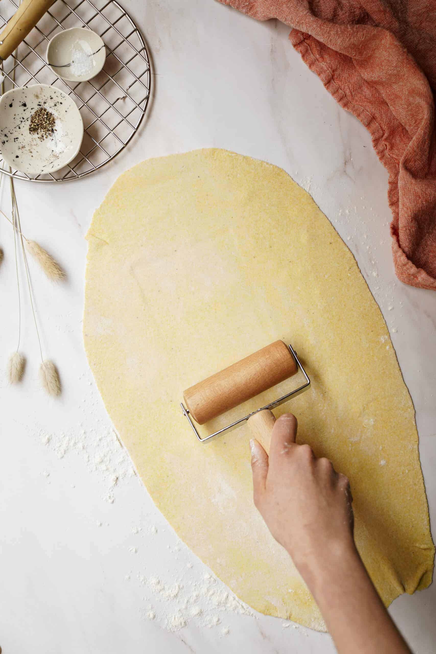 Pasta dough being rolled on counter