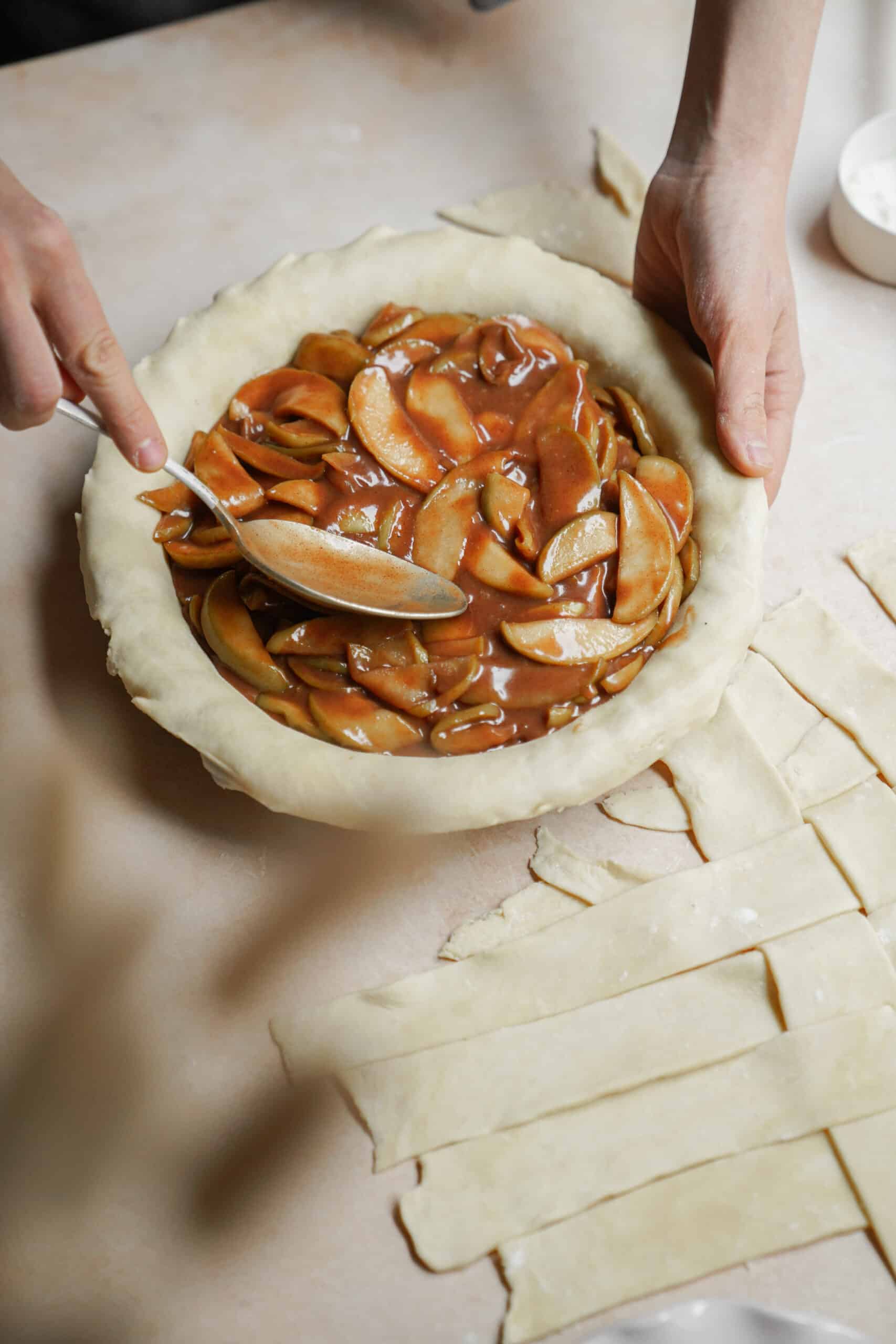 Filling being added to apple pie