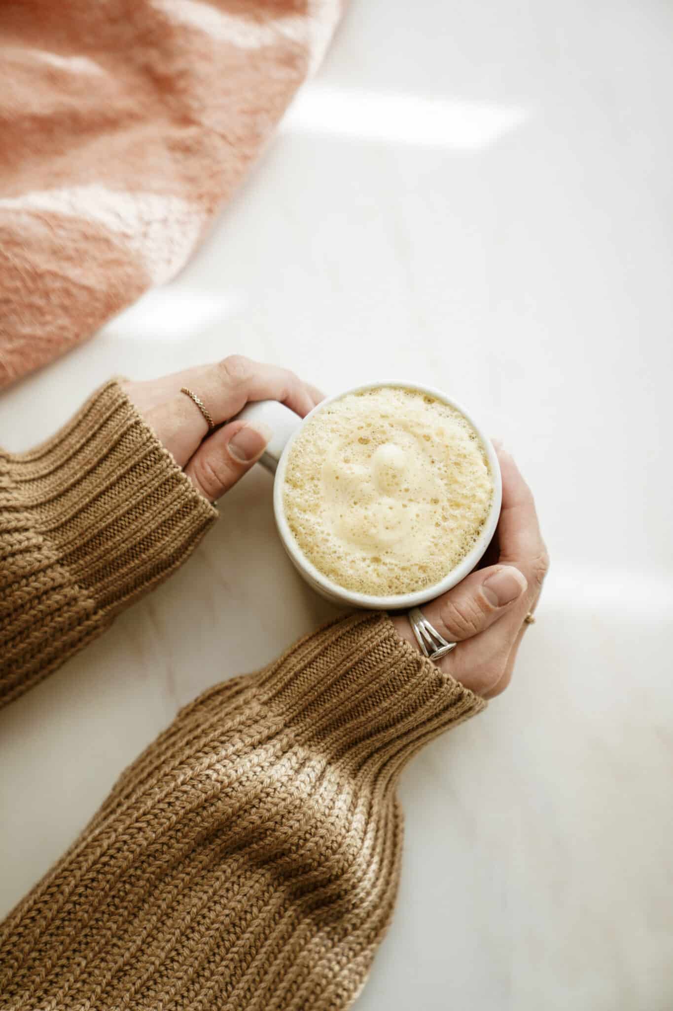 Hands holding mug of PSL