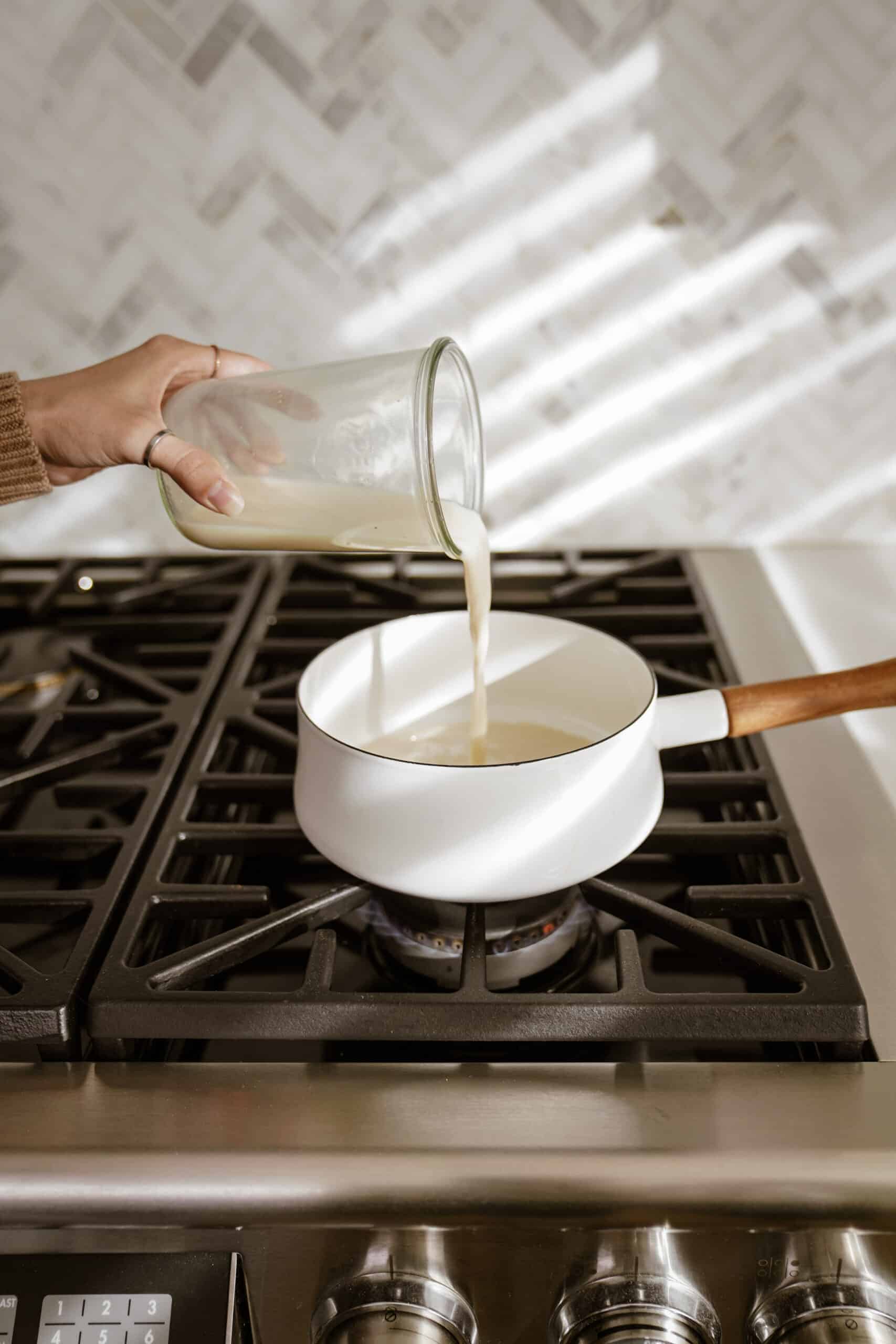 Milk being poured in pan for pumpkin spice latte