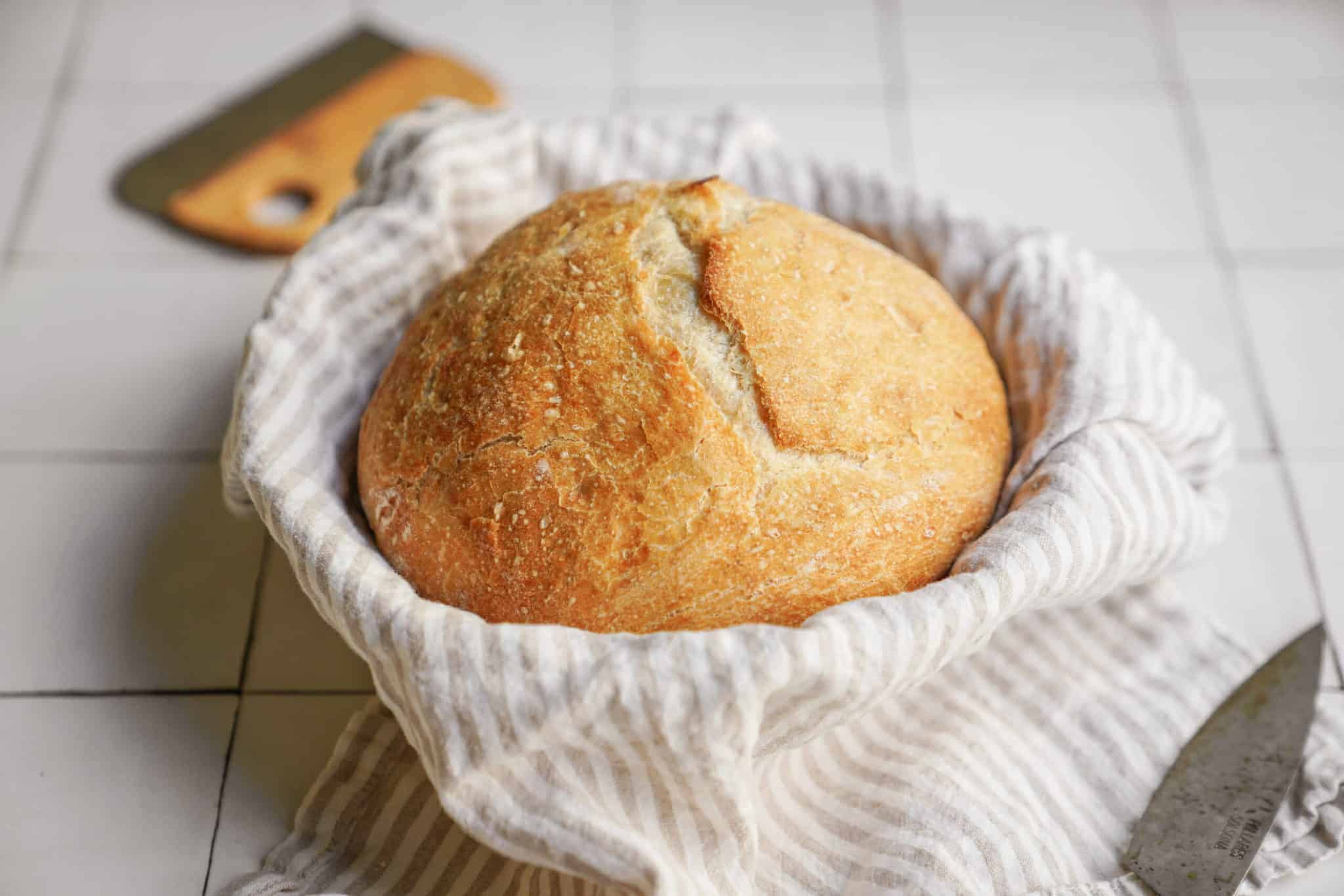 Loaf of No-Knead Bread Recipe in a bread basket