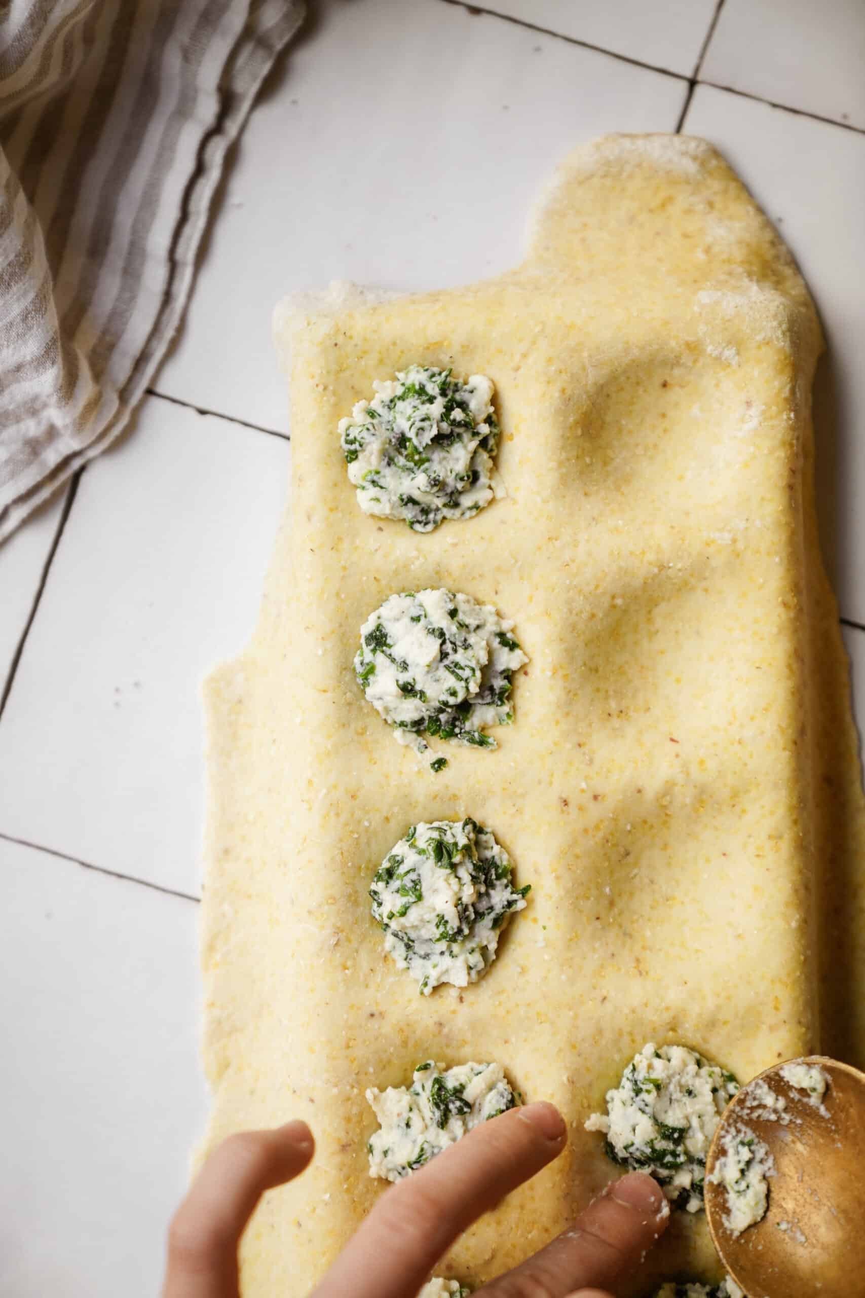 Spinach and Ricotta Ravioli being made in ravioli maker