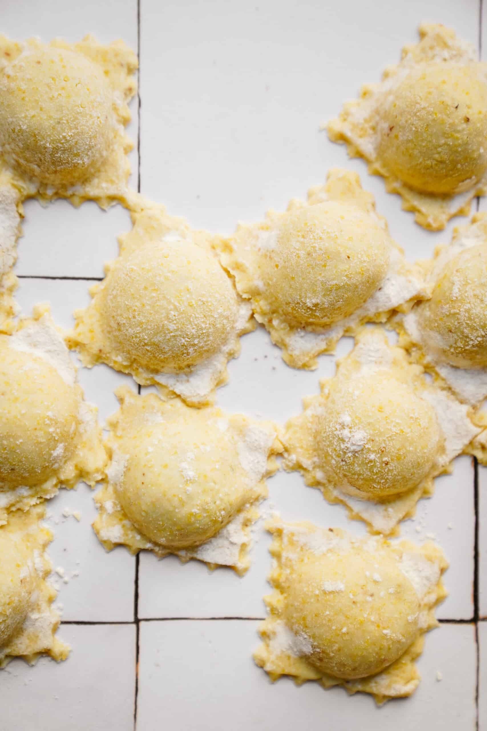 Uncooked Spinach and Ricotta Ravioli on counter