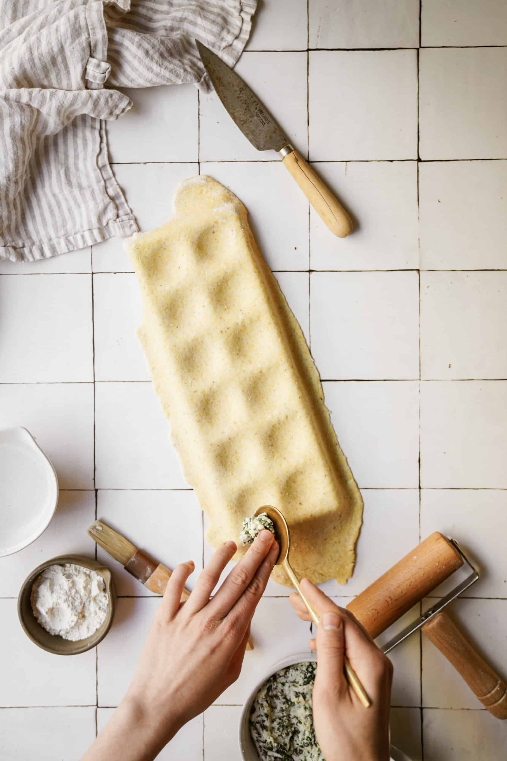 Dough being placed on ravioli maker