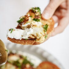 Pita chip dipping into whipped feta dip