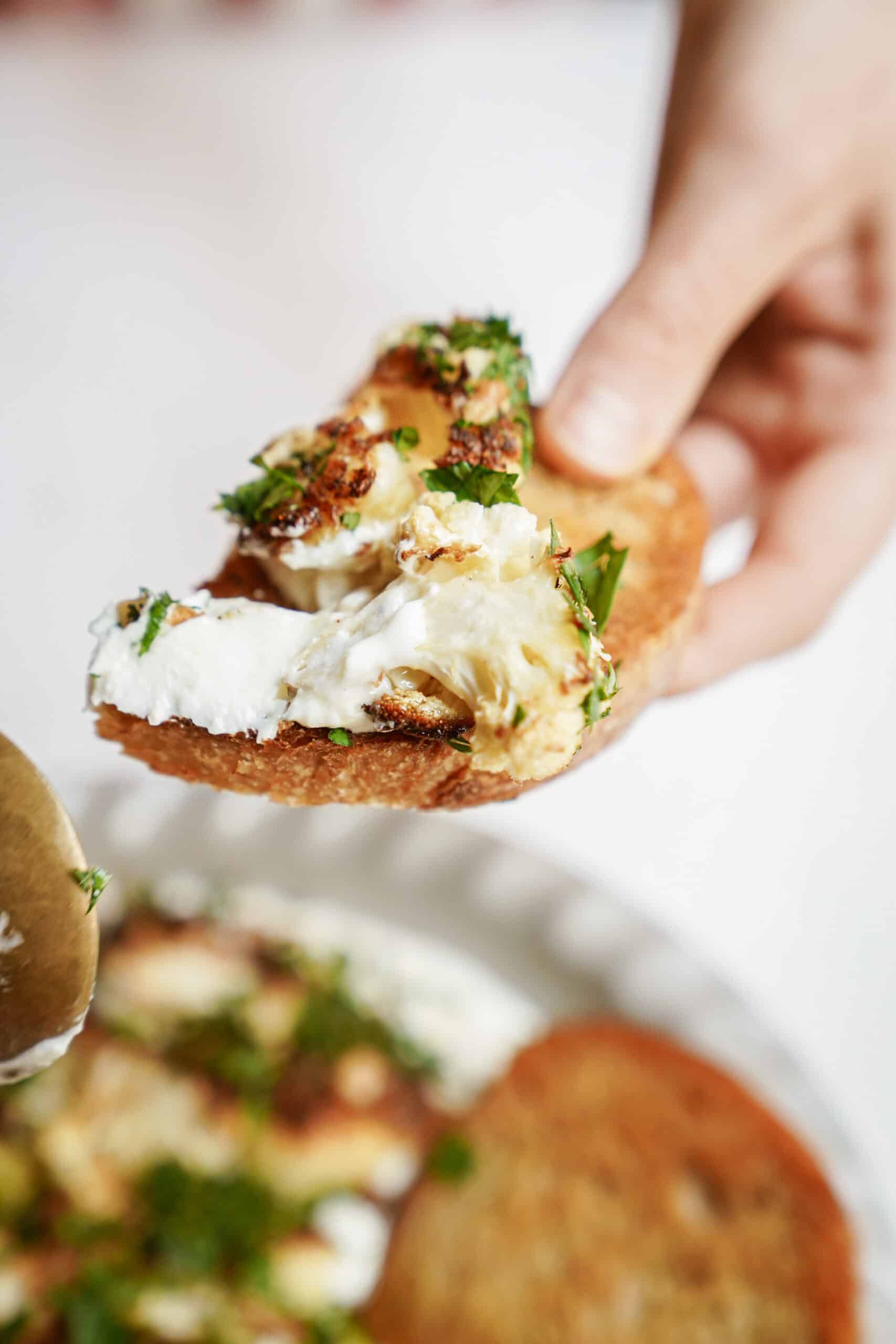 Pita chip dipping into whipped feta dip