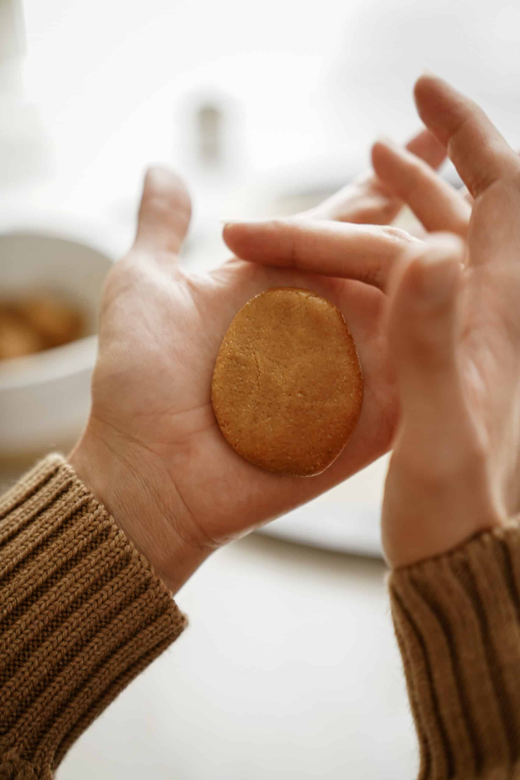 Peanut butter batter being shaped into an egg