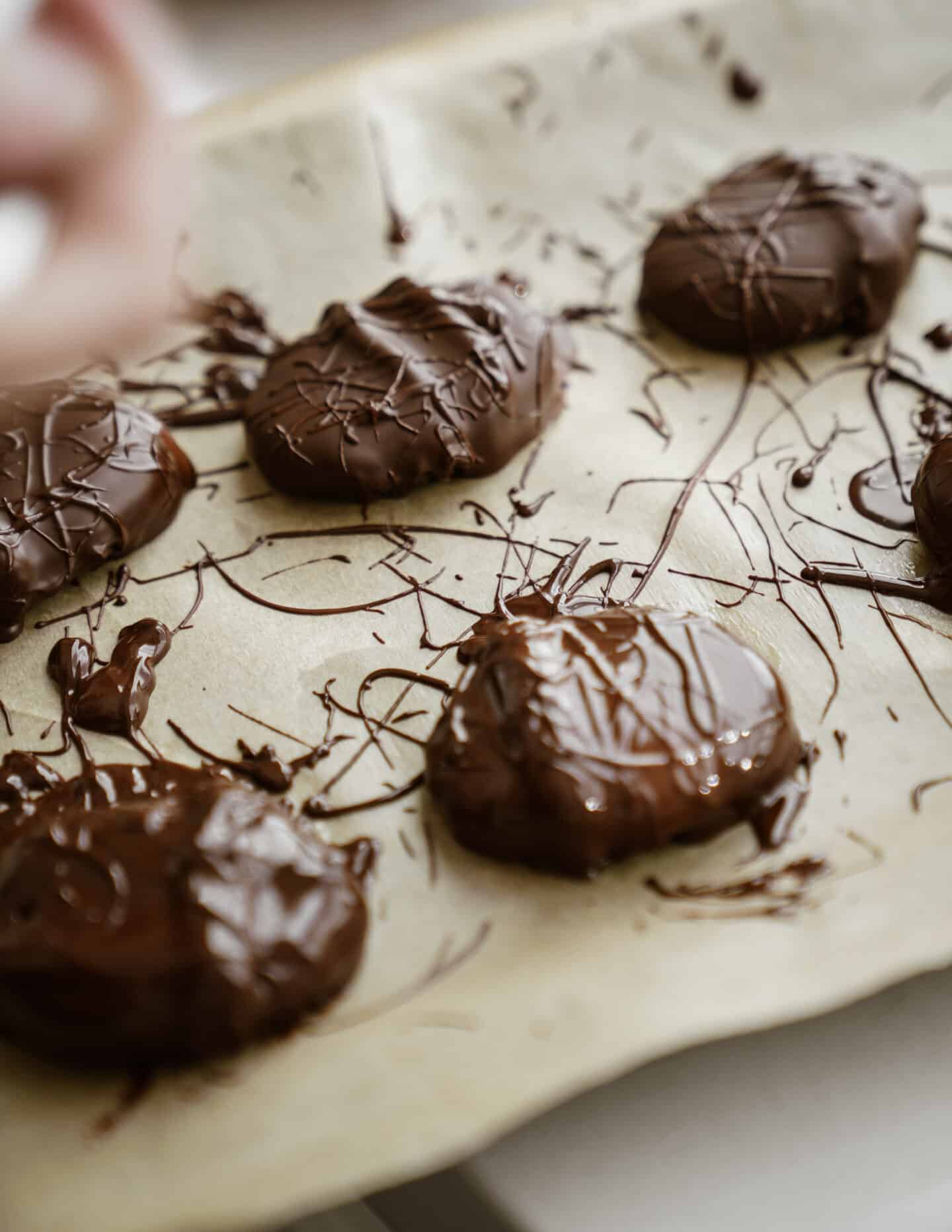 Homemade Reese's Eggs on a tray with drizzles of chocolate on them