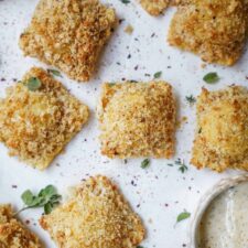 Baked ravioli on a white surface