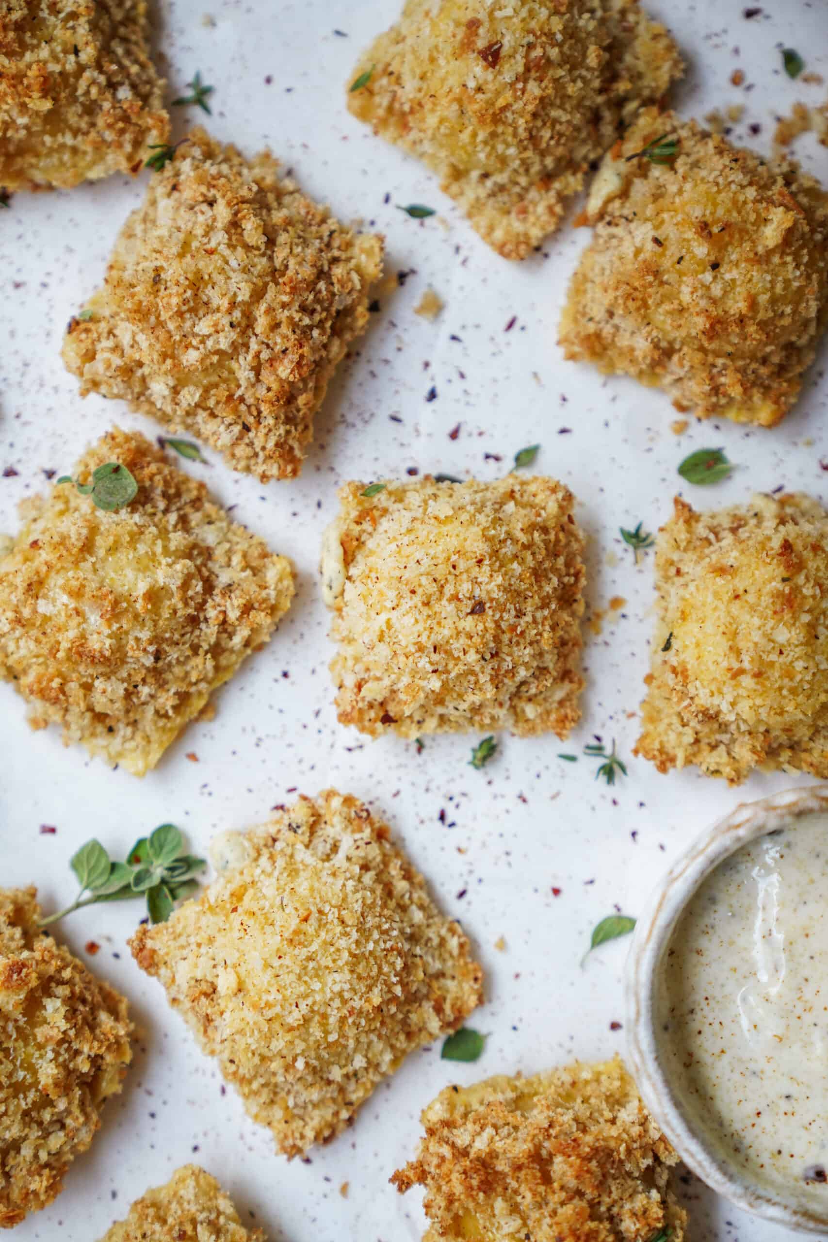 Baked ravioli on a white surface