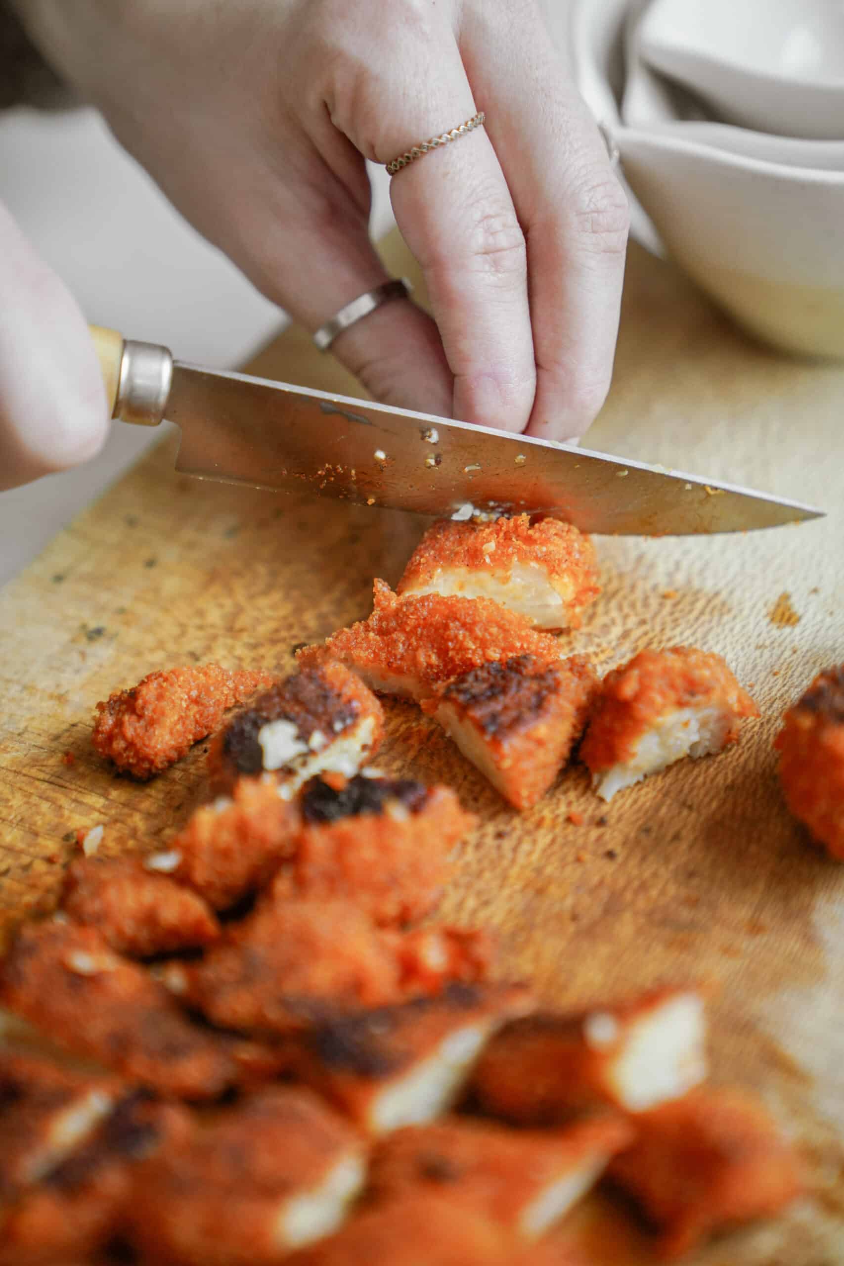 Cauliflower chicken wings being cut into pieces